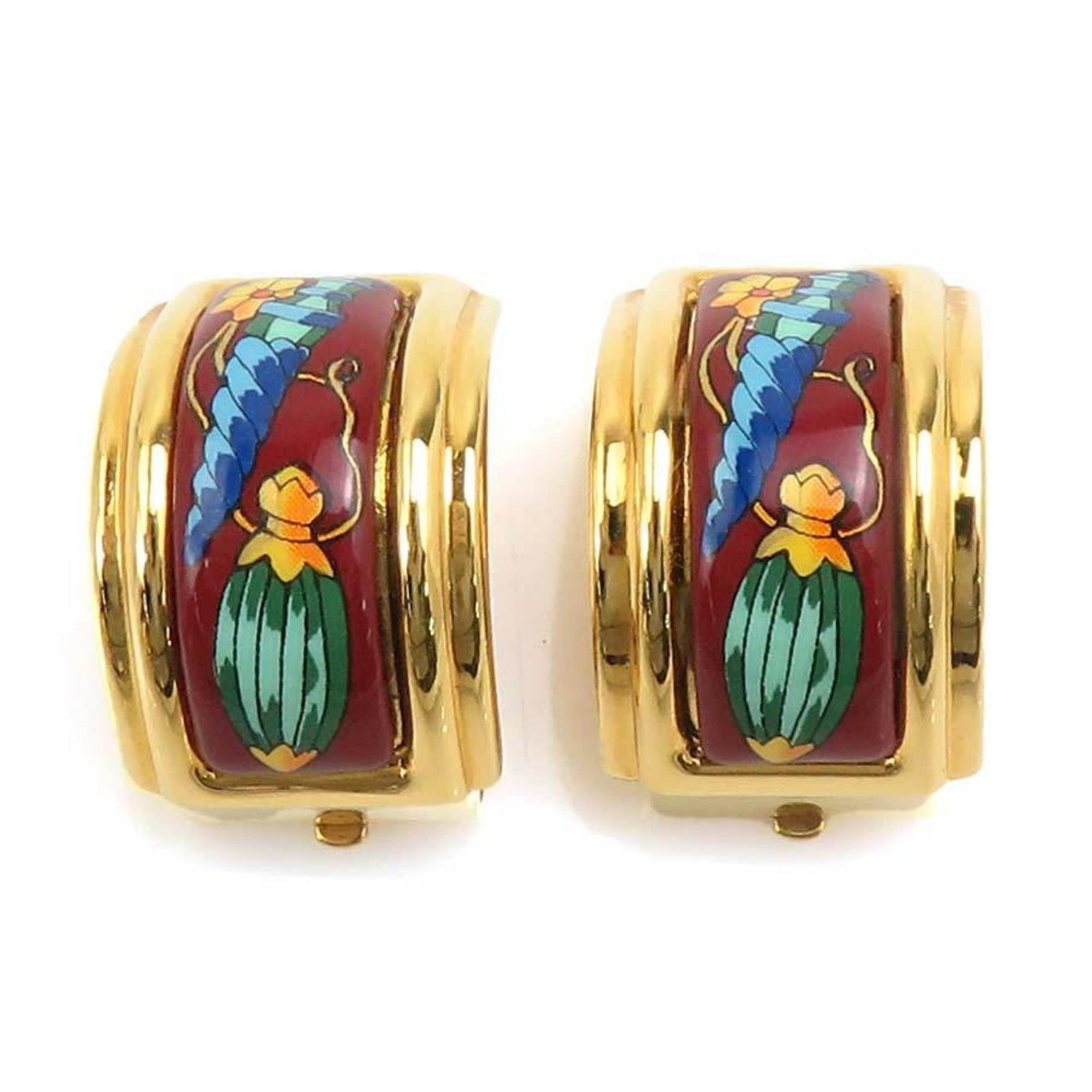 Enamel metal Hermes earrings clip: Enamel metal Hermes earrings clip The Hermes enamel metal clip earrings are a striking gold and multi-color design, featuring intricate details that add to their charm. Made from high-quality enamel