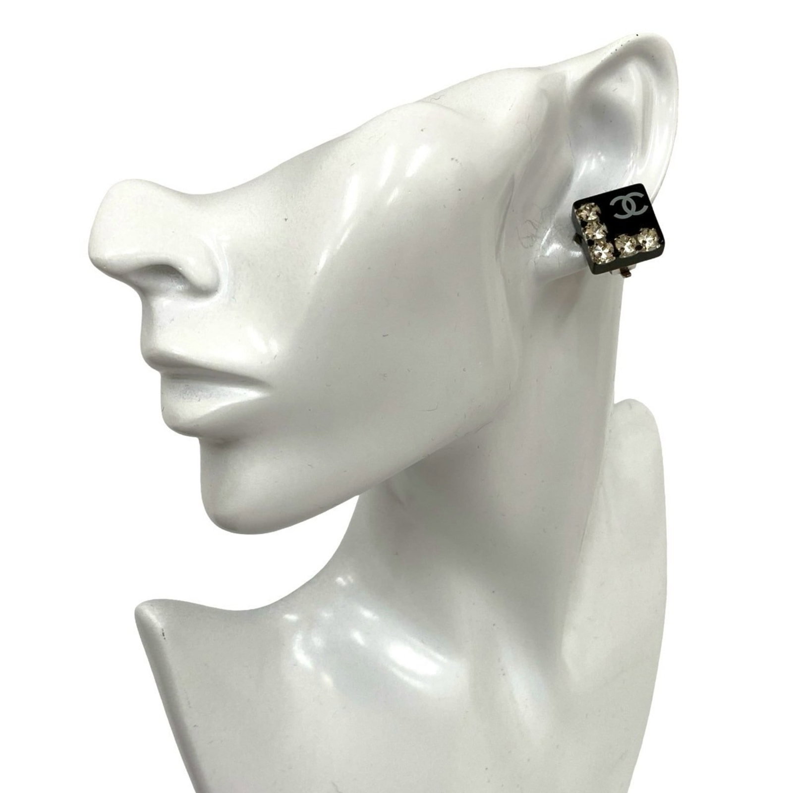 Earcuff by Plastic Chanel: Earcuff by Plastic Chanel The Earcuff by Plastic Chanel features a striking black finish with intricate rhinestone details, adding a touch of glamour to any outfit. This used earcuff measures 15mm x 1