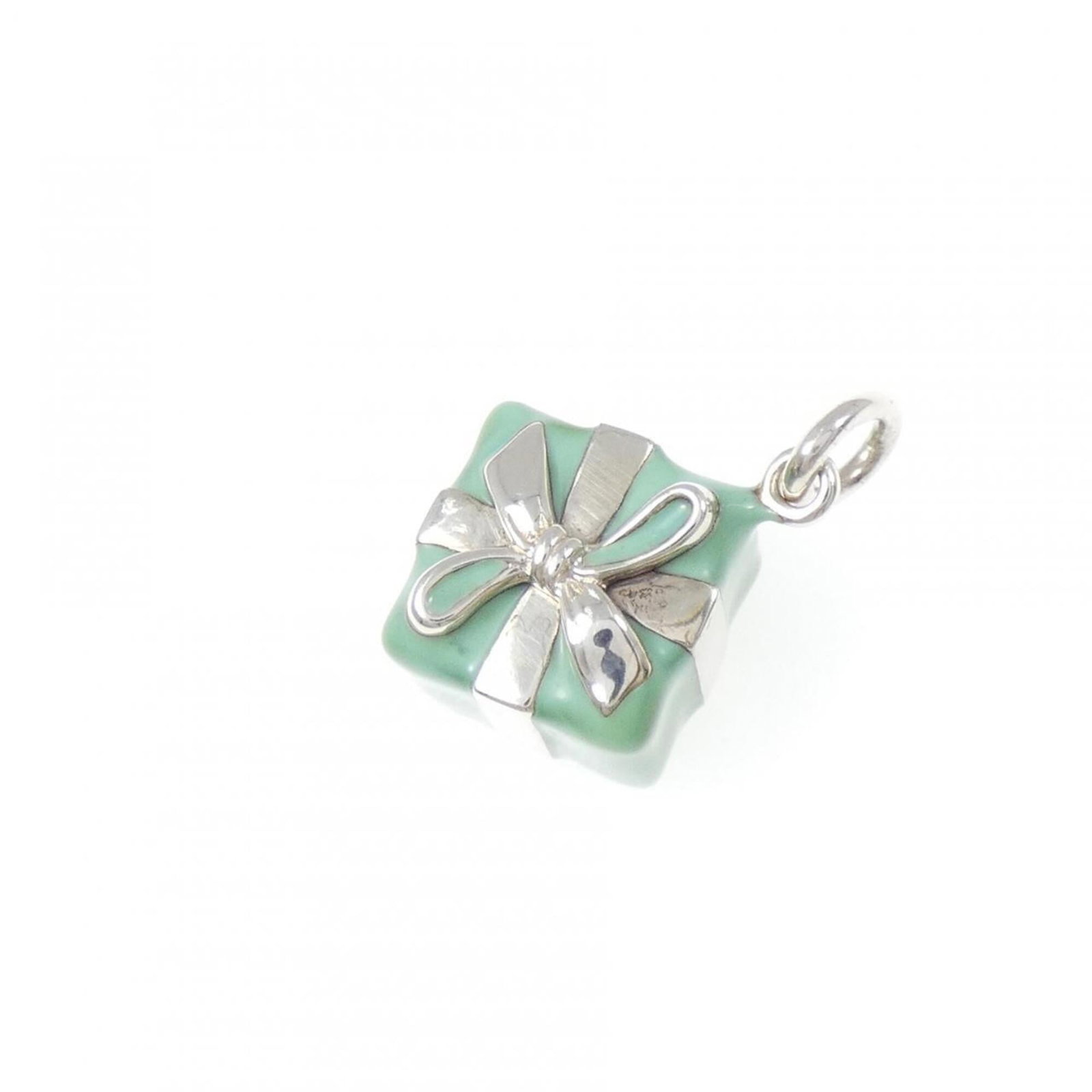 Blue Box Pendant by Tiffany: Blue Box Pendant by Tiffany Silver pendant by Tiffany featuring blue box design, measuring 23.8mm x 14.6mm. This used item has traces of usage and minor damages/dirt, still in acceptable condition for