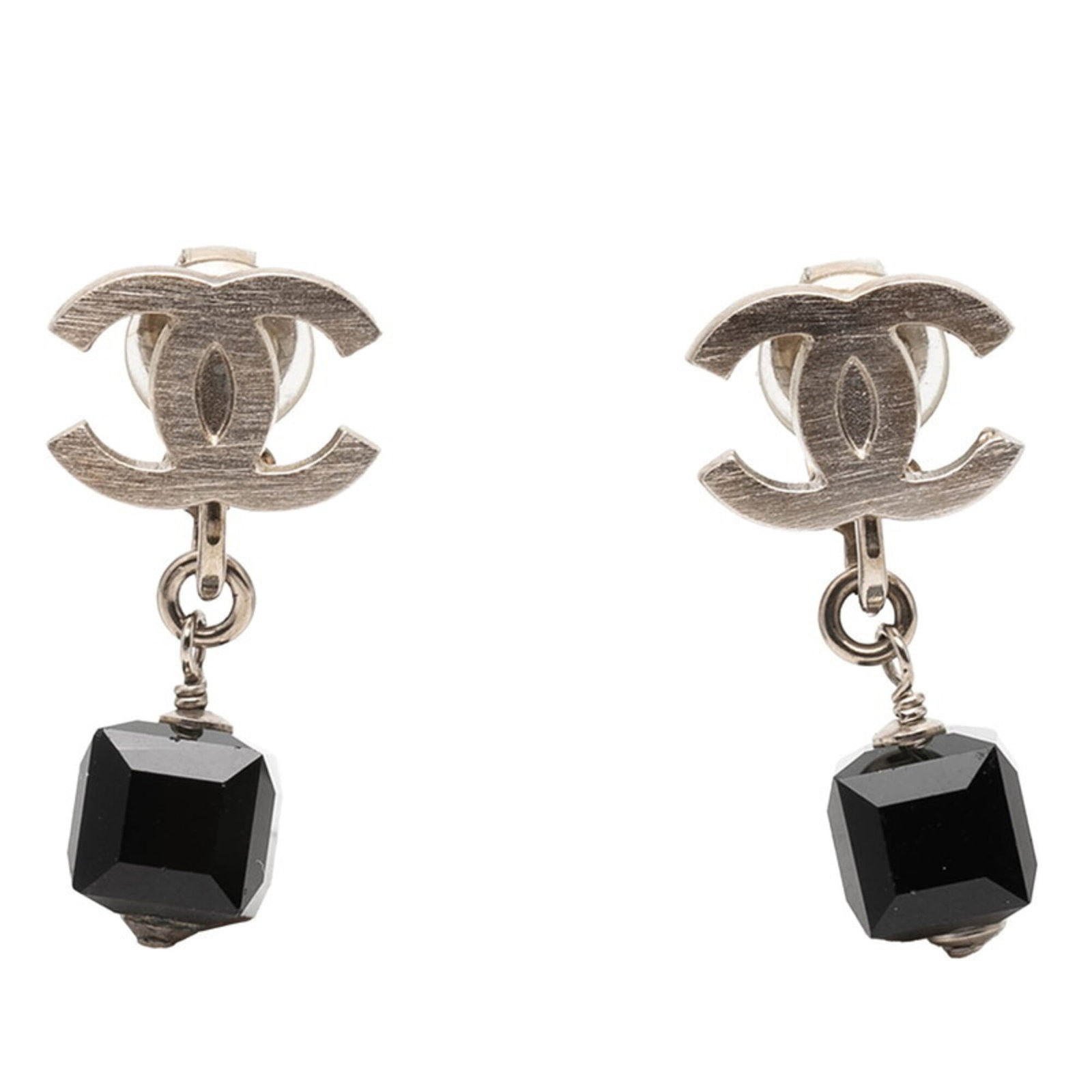 Metal clip earrings by Chanel: Metal clip earrings by Chanel Metal clip earrings by Chanel, featuring a sleek black and silver design with subtle signs of wear. The earrings are made from metal and plastic materials and measure 28.