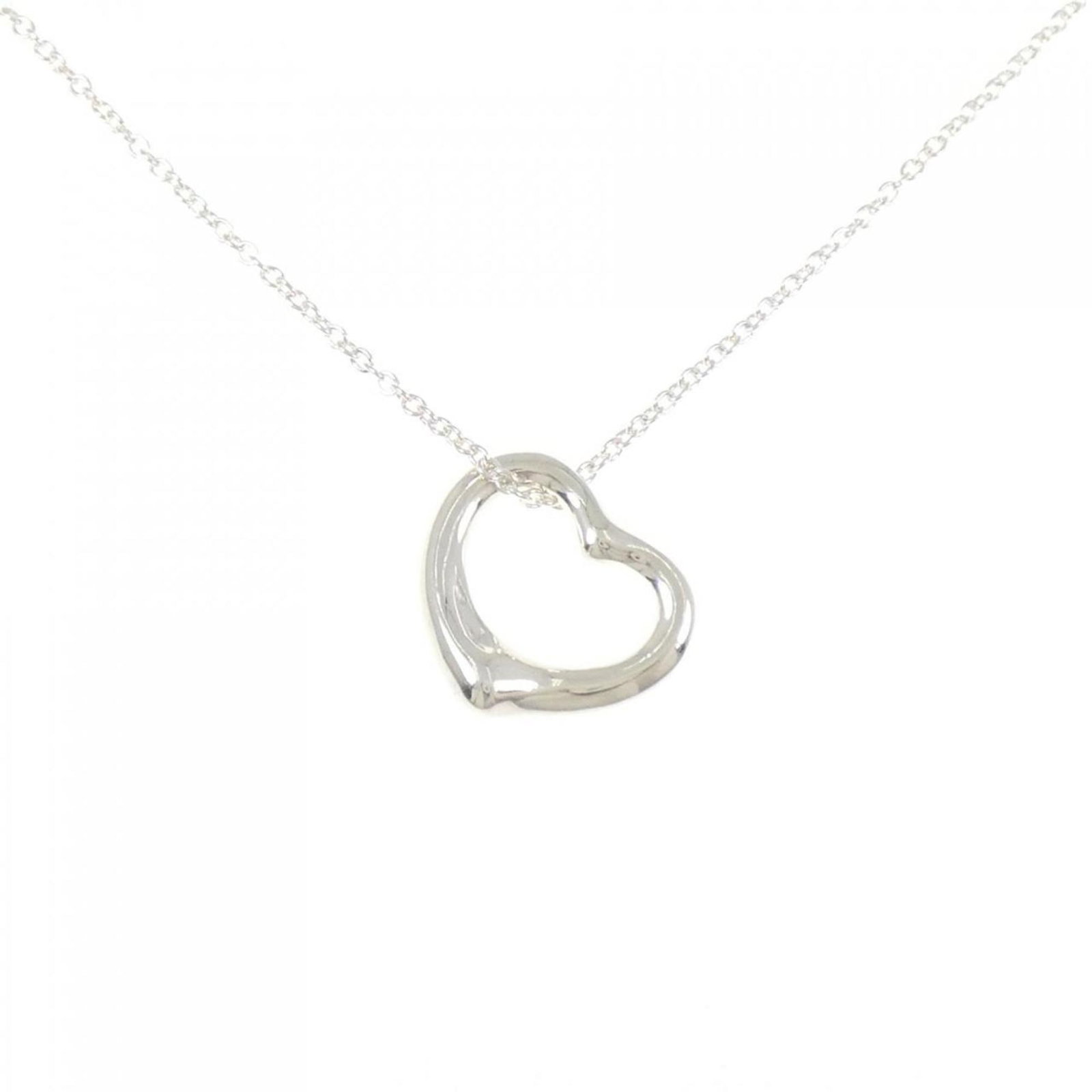Heart Open Tiffany Necklace: Heart Open Tiffany Necklace This Heart Open Tiffany Necklace features a beautiful silver pendant with intricate details, showcasing the brand's signature style. The necklace type and material are clea