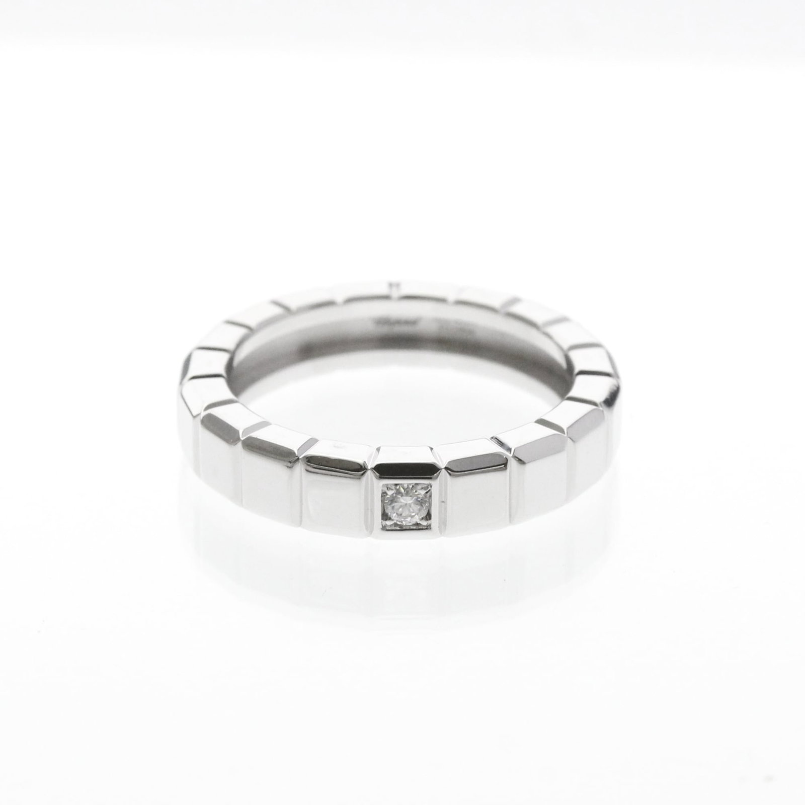Chopard 18k White Gold Band Ring: Chopard 18k White Gold Band Ring Chopard's 18k white gold band ring boasts elegant simplicity with its slender profile and delicate width. This fashion-forward design features a diamond stone set in a