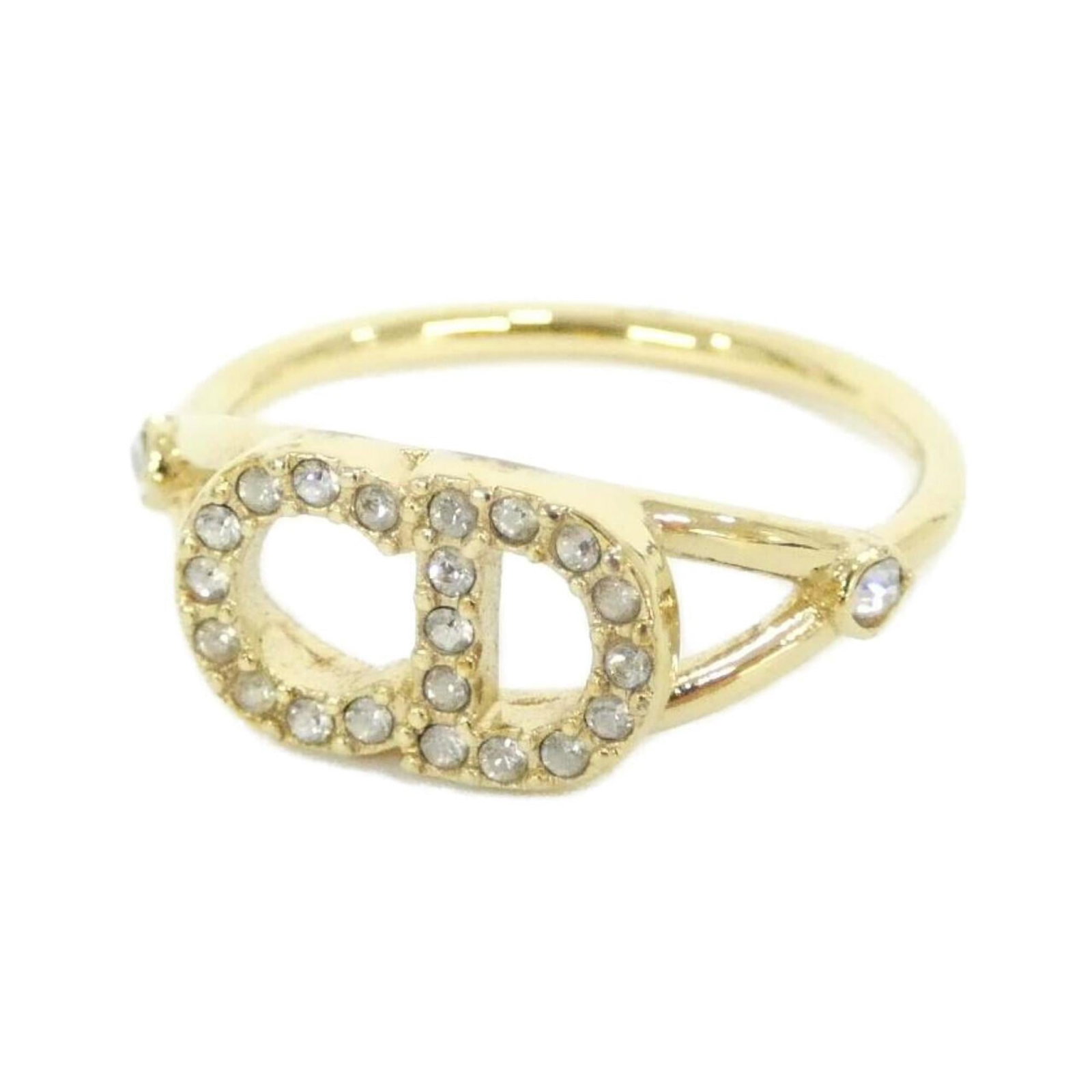 Christian Dior Ring: Christian Dior Ring The Christian Dior band ring boasts clear, gold hues and a classic design. With a slight wear from usage, this piece still shines with its signature style. A few minor scratches an