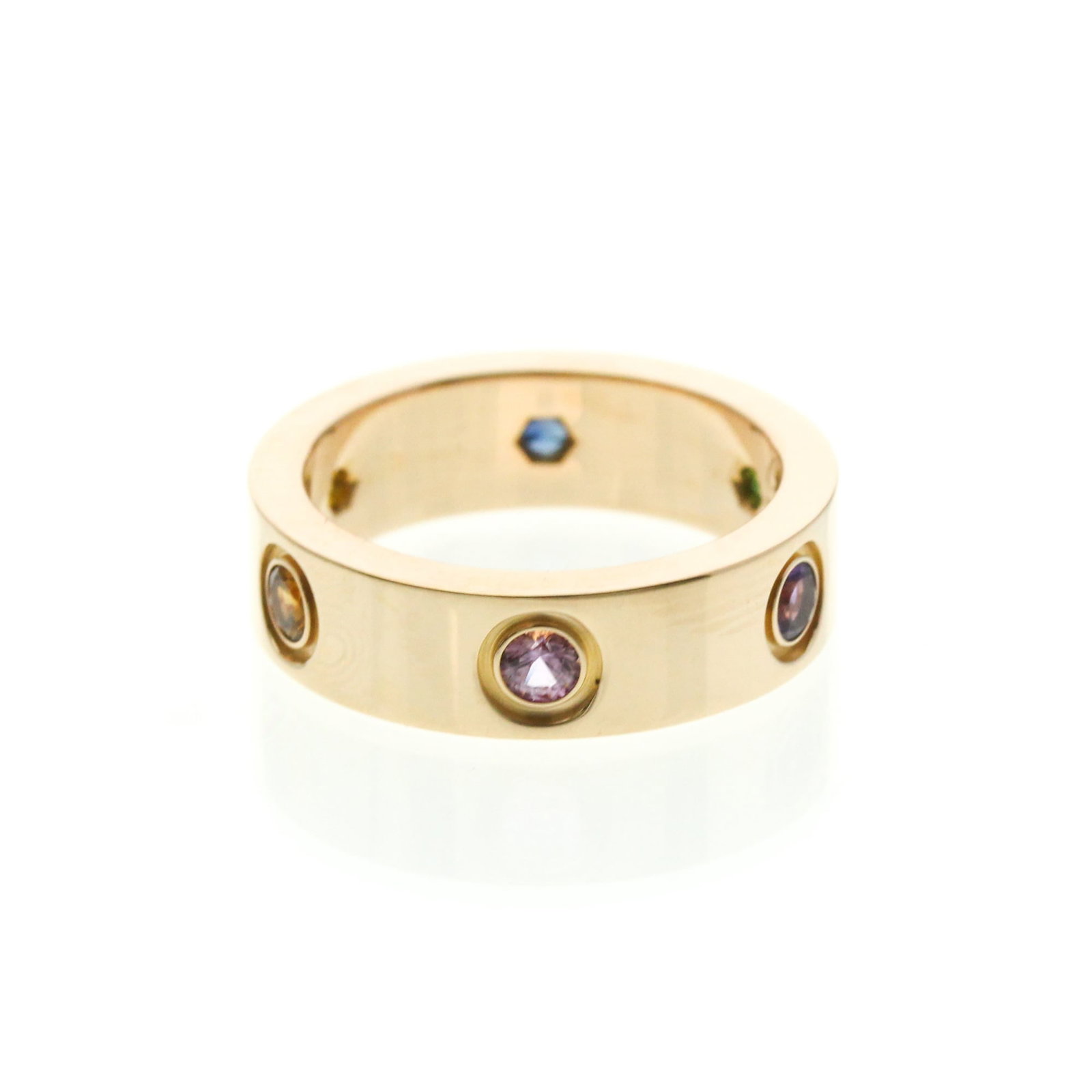 Pink gold 18k ring band from Cartier: Pink gold 18k ring band from Cartier Pink gold 18k band from Cartier features an elegant design with amethyst, garnet, and sapphire stones. The ring measures 5.6mm in width and weighs 9.1g, showcasing