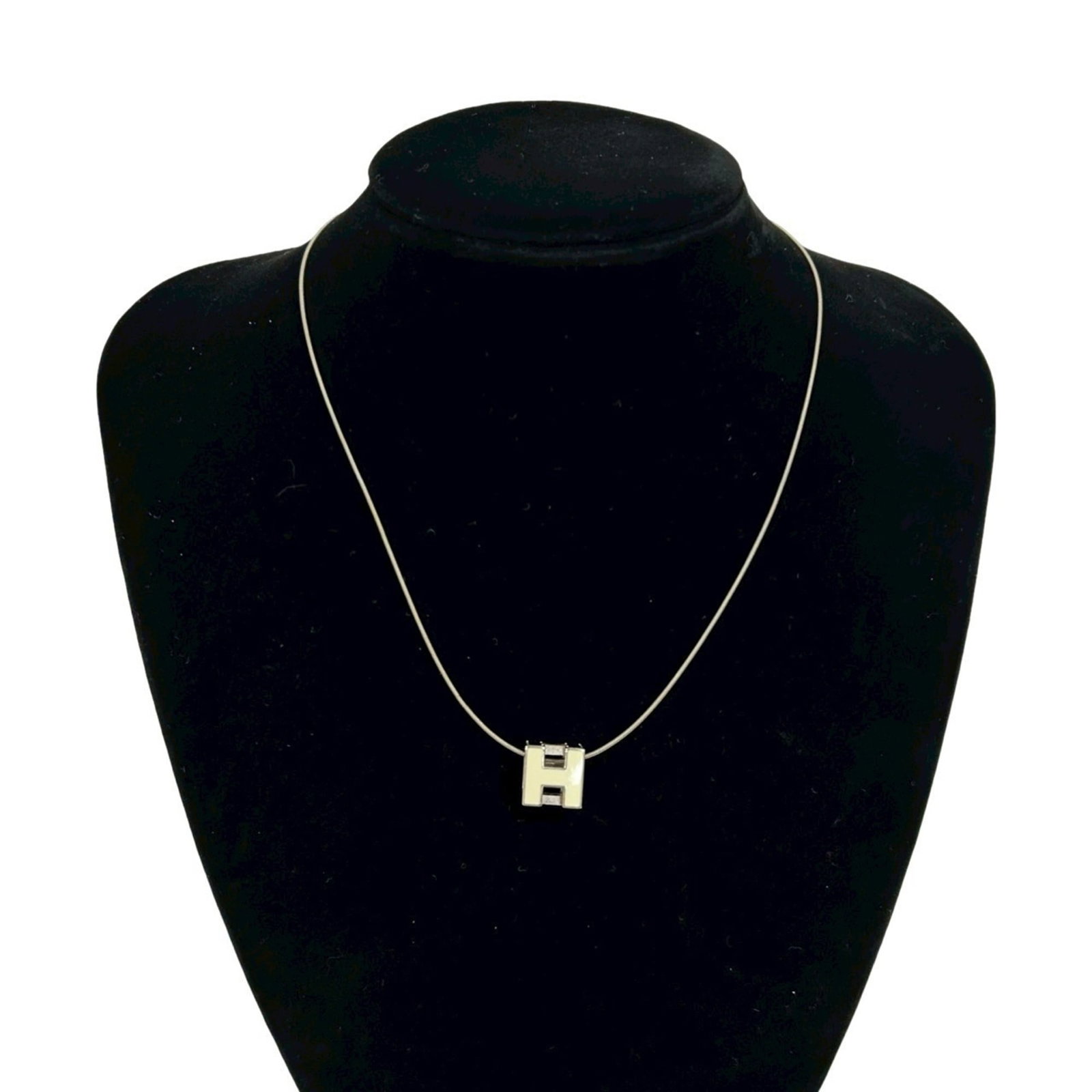 Hermes Herms Case D'Ache H-Cube Metal Necklace Pendant In Silver And Off-White 1606B: Hermes Herms Case D'Ache H-Cube Metal Necklace Pendant In Silver And Off-White 1606B Silver and off-white metal necklace pendant from Hermes, featuring the iconic D'Ache H-Cube design. The 11mm x 11mm