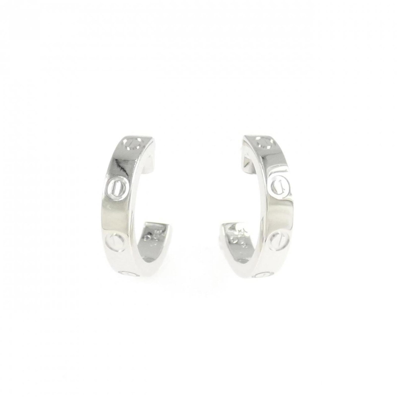 STUD EARRINGS WHITE GOLD 18K CARTIER: STUD EARRINGS WHITE GOLD 18K CARTIER Cartier's iconic stud earrings in white gold 18K feature a sleek and timeless design. The earrings showcase subtle scratches and minor dirt, giving them a worn-in 