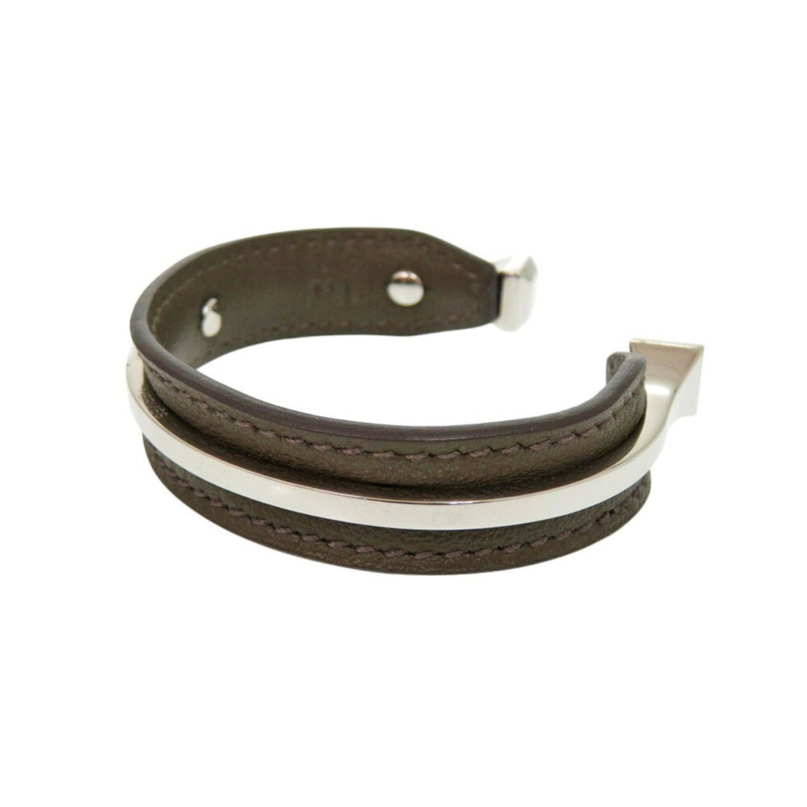 Metal swift leather bangle Hermes: Metal swift leather bangle Hermes Metal swift leather bangle from Hermes features brown and silver accents, with a length of 14.5cm / 5.7''. This used bangle has some traces of usage, including