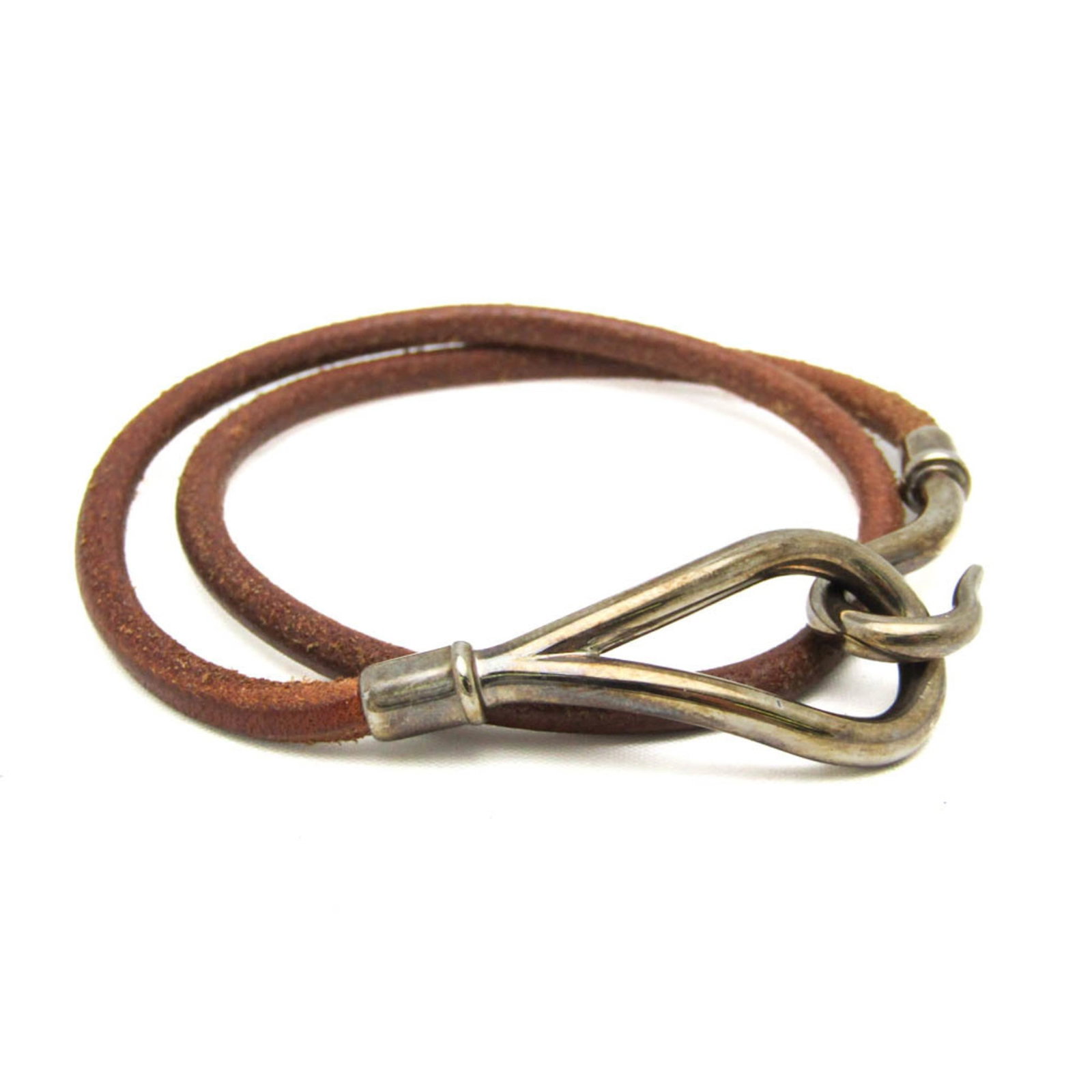 Metal leather bangle Hermes: Metal leather bangle Hermes This metal leather bangle from Hermes features a rich brown and silver combination, with a classic hook closure. Measuring between 17cm to 38cm in length, it offers a versa