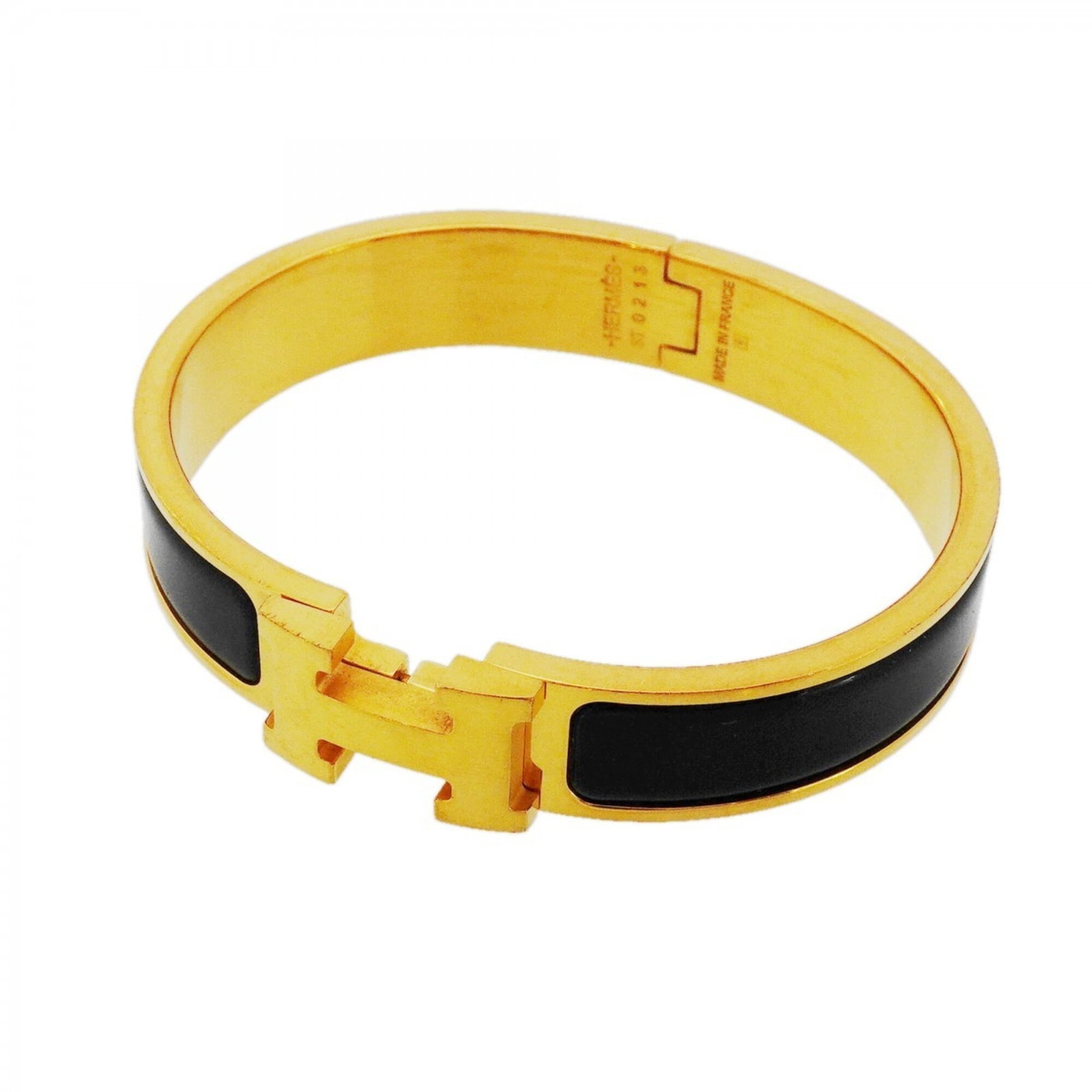 Hermes Bangle Gold Plating: Hermes Bangle Gold Plating Gold plated bangle from Hermes with black and gold accents, measuring 16cm in length. This used item shows traces of usage and minor damages, but remains in acceptable condi