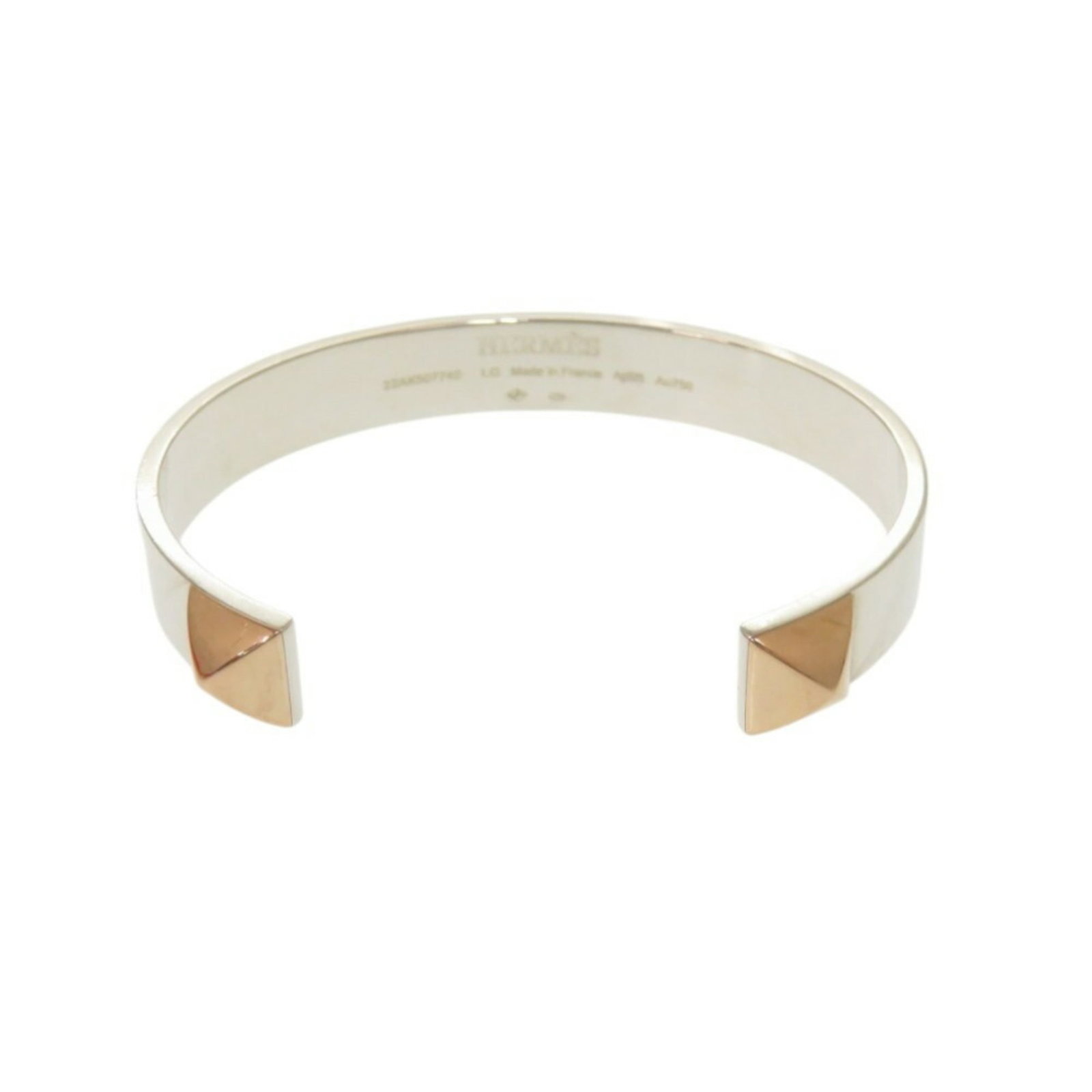 Hermes Bangle Pink Gold (18K) Silver 925: Hermes Bangle Pink Gold (18K) Silver 925 Pink Gold (18K) and Silver 925 details add an elegant touch to this Hermes bangle. Traces of usage are visible, with minor scratches and dirt, but the overall 