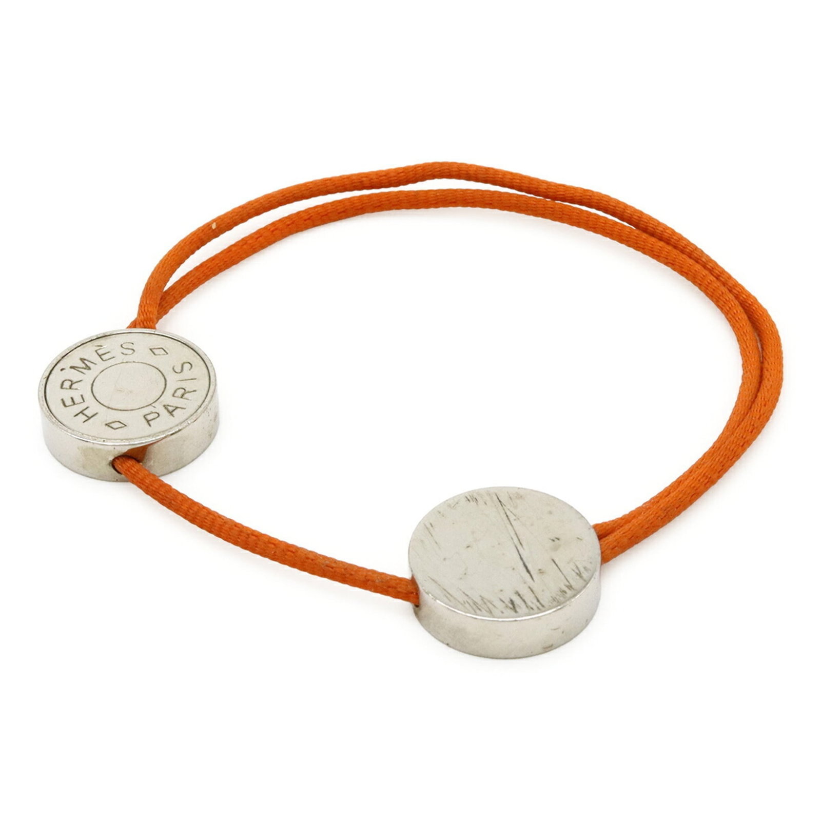 Metal cotton charm bracelet by Hermes: Metal cotton charm bracelet by Hermes Cotton and metal charm bracelet with an orange hue, adorned with silver accents, measuring 24.5cm in length. The bracelet bears signs of previous use, with visibl