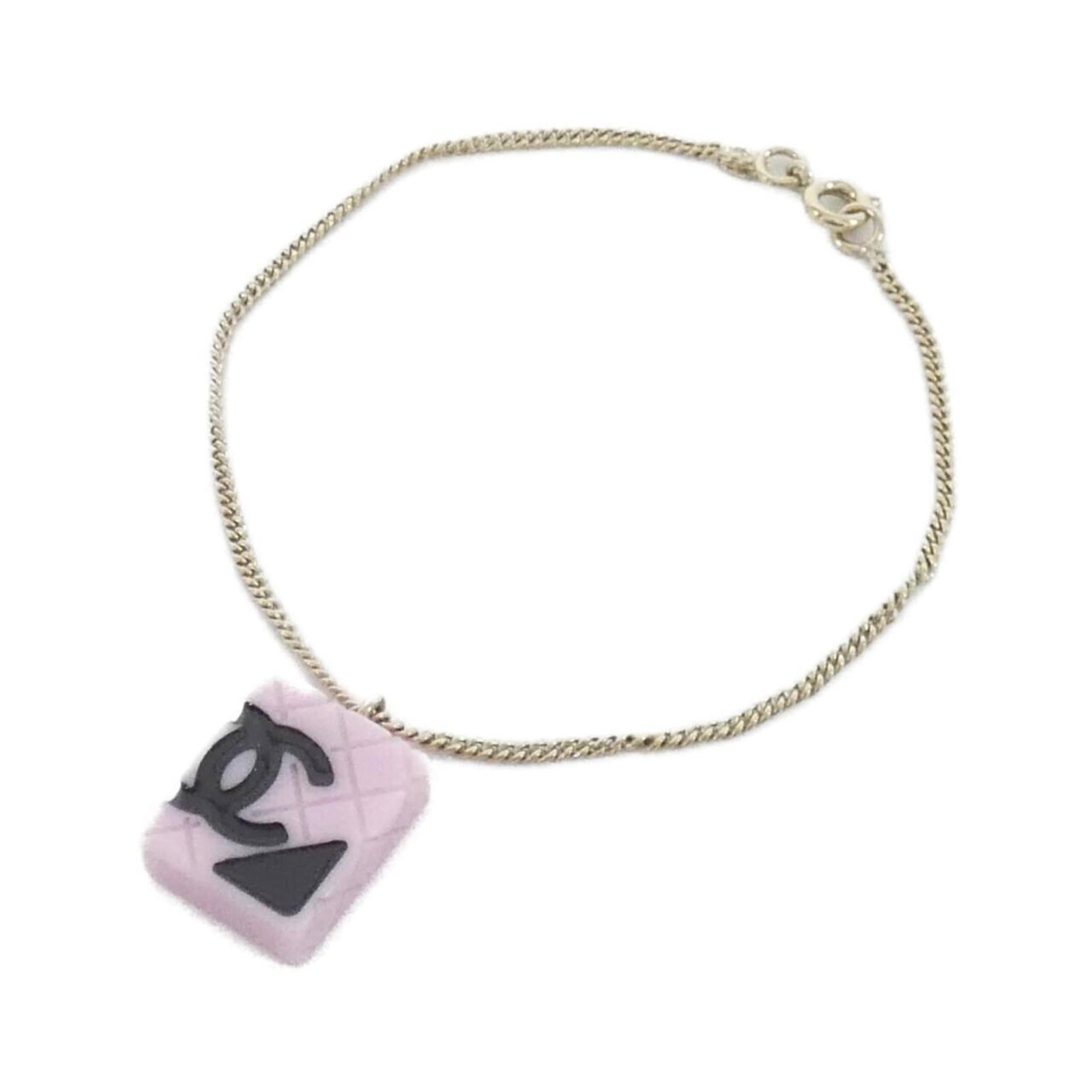 Charm of Chanel: Charm of Chanel This Charm of Chanel bracelet features a sleek black, gold, and pink design with a length of 19.5cm. The item bears some minor scratches and dirt, but remains in very good condition ov