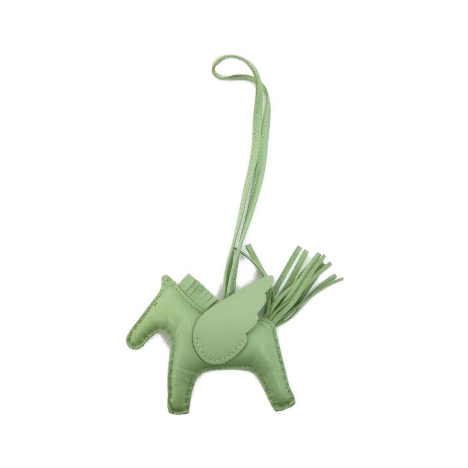 Hermes Handbag Charm Agneau Milo: Hermes Handbag Charm Agneau Milo Agneau Milo, the iconic material used in this Hermes Handbag Charm, adds a touch of sophistication to any accessory. The charm's subtle green hue and unique design mak