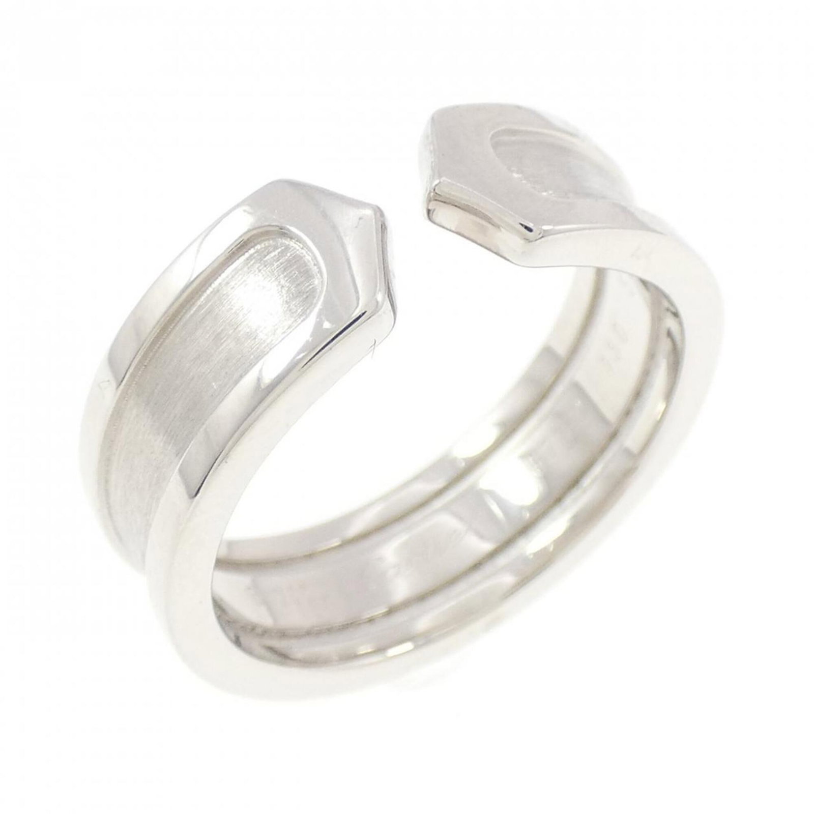 White Gold Cartier Band Ring 18K: White Gold Cartier Band Ring 18K White Gold Cartier Band Ring 18K features an 18K white gold band, bearing the iconic Cartier brand. The ring has been worn and shows signs of usage, with minor scratch