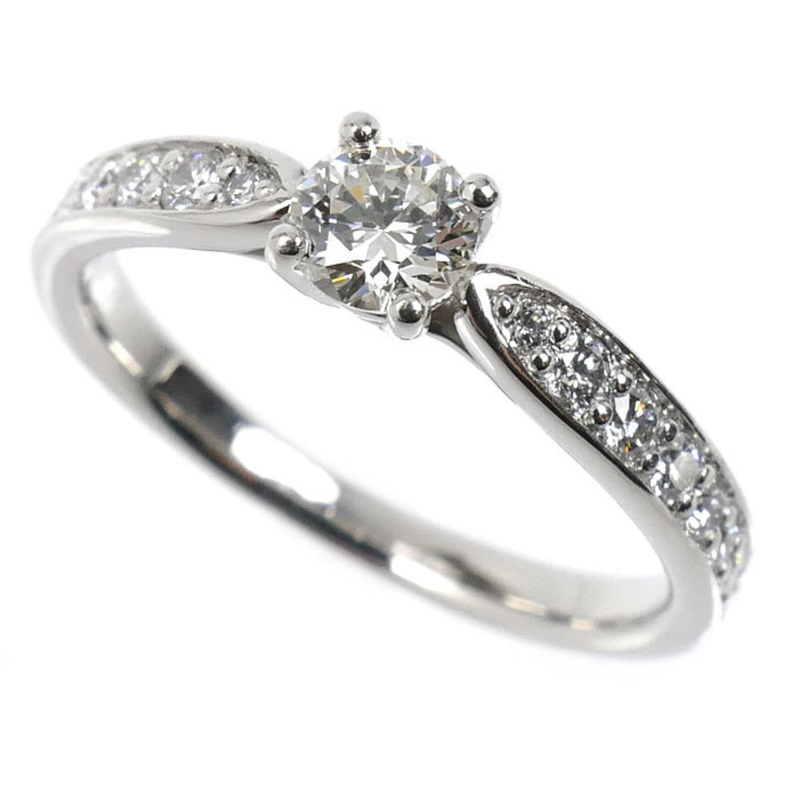 Platinum ring by Tiffany band: Platinum ring by Tiffany band Platinum ring by Tiffany features a diamond stone set in a band design. The item has been worn and shows signs of usage, with some scratches and dirt present, but remains