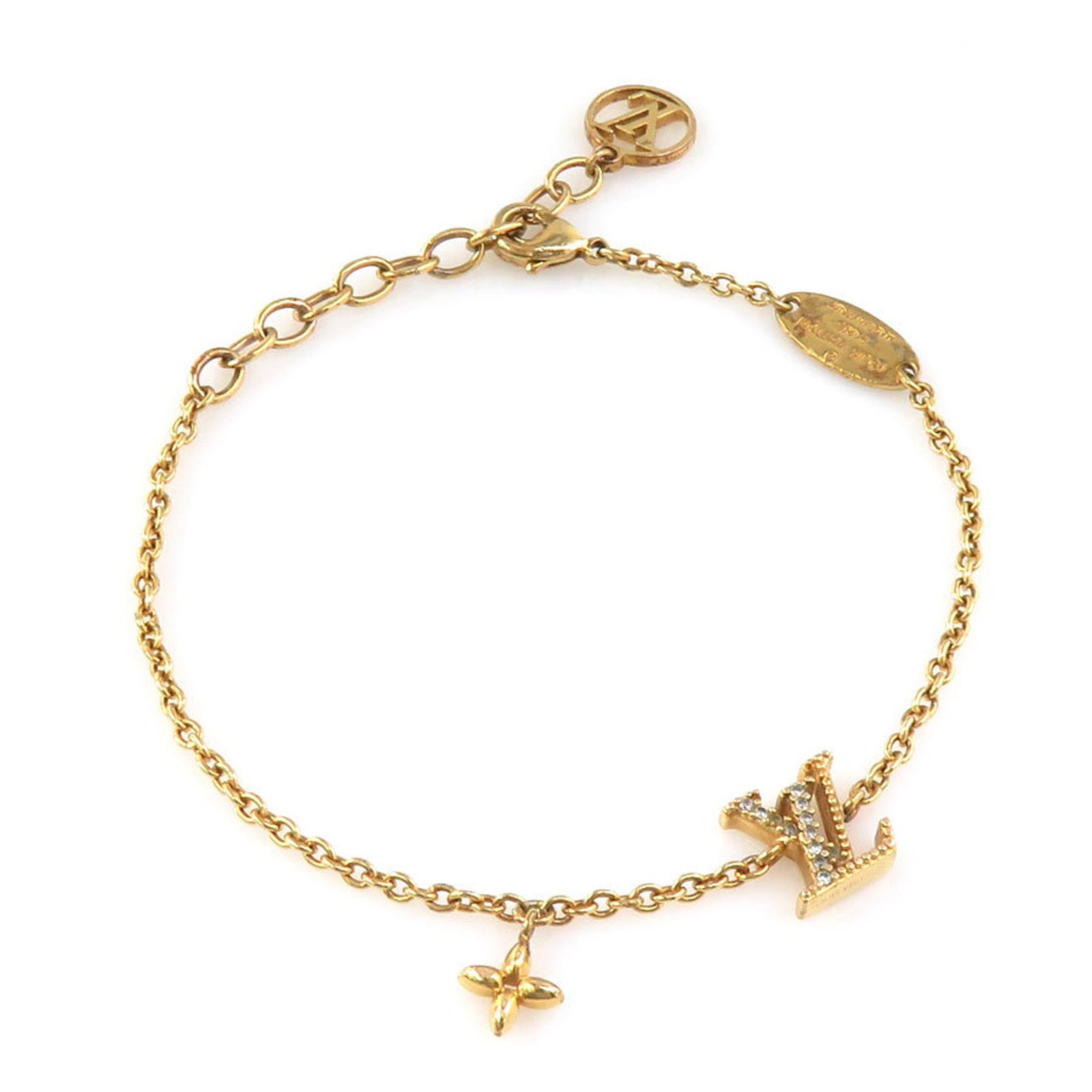 Rhinestone Charm Metal Louis Vuitton: Rhinestone Charm Metal Louis Vuitton Gold-plated metal Louis Vuitton charm bracelet adorned with rhinestones, measuring 18cm in length. The bracelet bears traces of usage and minor scratches, but