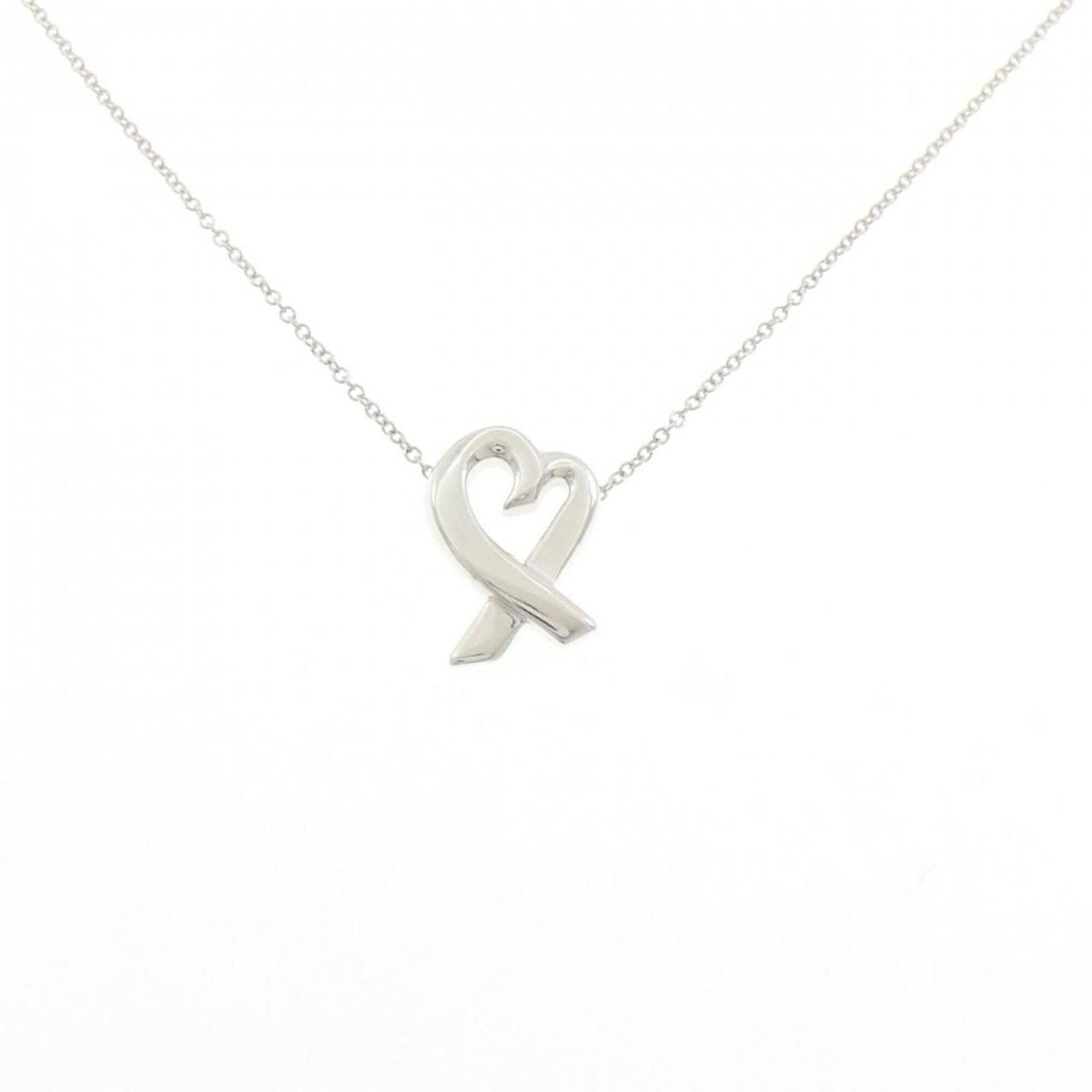 Small Loving Heart Necklace by Tiffany: Small Loving Heart Necklace by Tiffany Silver 925 chain and pendant combination, featuring a small loving heart design in silver. The necklace has a 42 cm circumference and bears some minor scratches 
