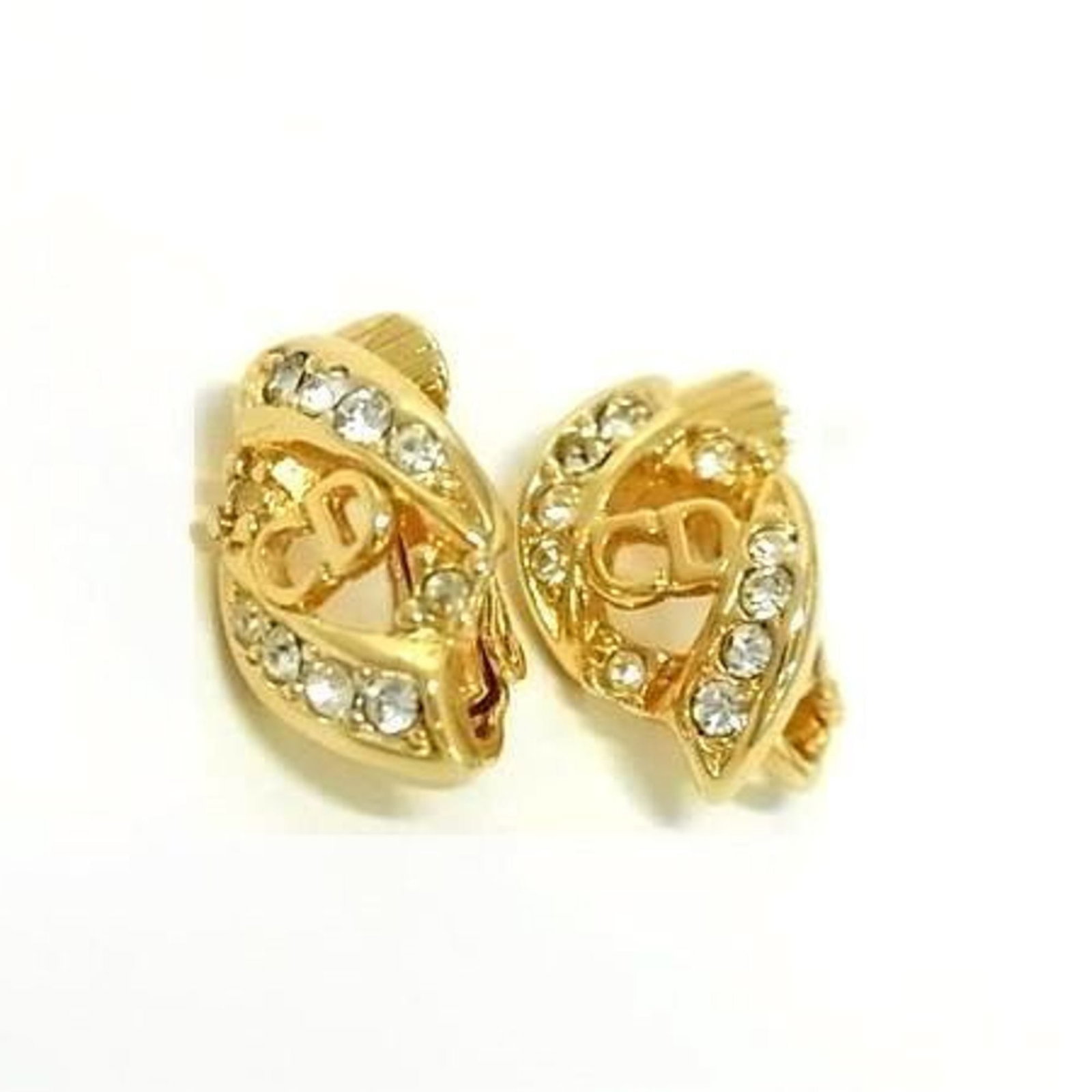 Metal clip earrings by Christian Dior: Metal clip earrings by Christian Dior Gold metal clip earrings from Christian Dior, featuring rhinestone accents. With a size of 16.00mm x 10.00mm, these earrings showcase the luxury brand's signature