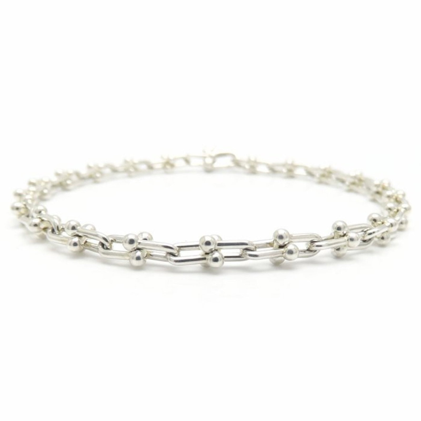 Silver Tiffany Link Bracelet: Silver Tiffany Link Bracelet Silver Tiffany Link Bracelet, featuring a delicate 925 silver chain with subtle scratches and minor dirt accumulation, showcasing its worn-in charm. This versatile bracele