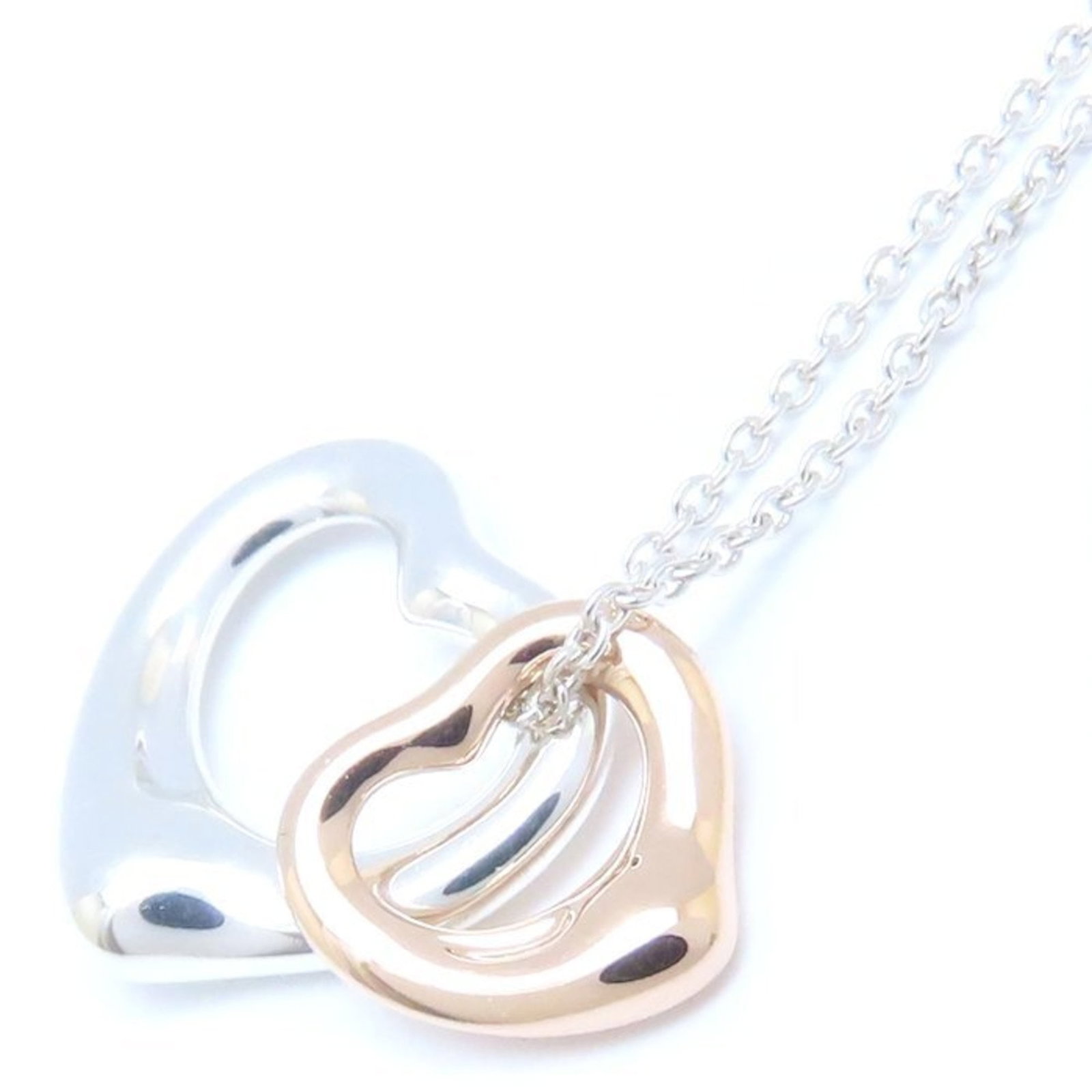 Tiffany Co Elsa Peretti Double Heart Necklace Silver Pink 925xk18pg: Tiffany Co Elsa Peretti Double Heart Necklace Silver Pink 925xk18pg Pink gold (18K) and silver 925 combine in this elegant Elsa Peretti double heart necklace from Tiffany & Co. The necklace features a