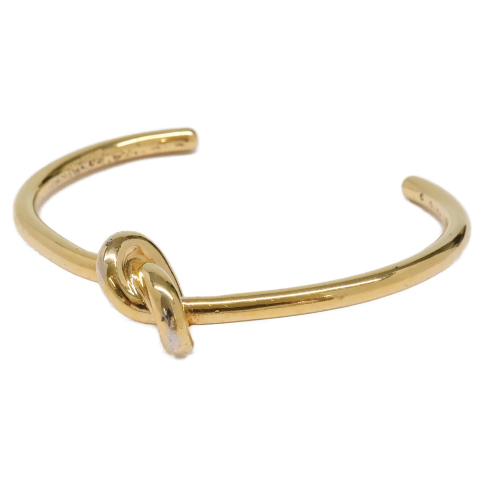 Celine Bangle: Celine Bangle Gold Celine Bangle, 14.5cm in length, bears the signature of its creator. Traces of usage are visible, with minor scratches and dirt present, but overall it remains in good condition. A