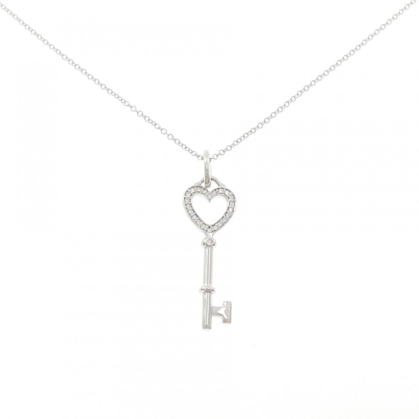 Diamond Necklace by Tiffany Co.: Diamond Necklace by Tiffany Co. Tiffany Co.'s diamond necklace boasts a stunning white gold pendant adorned with a precious stone, set against a sleek and sophisticated chain. The 46 cm length