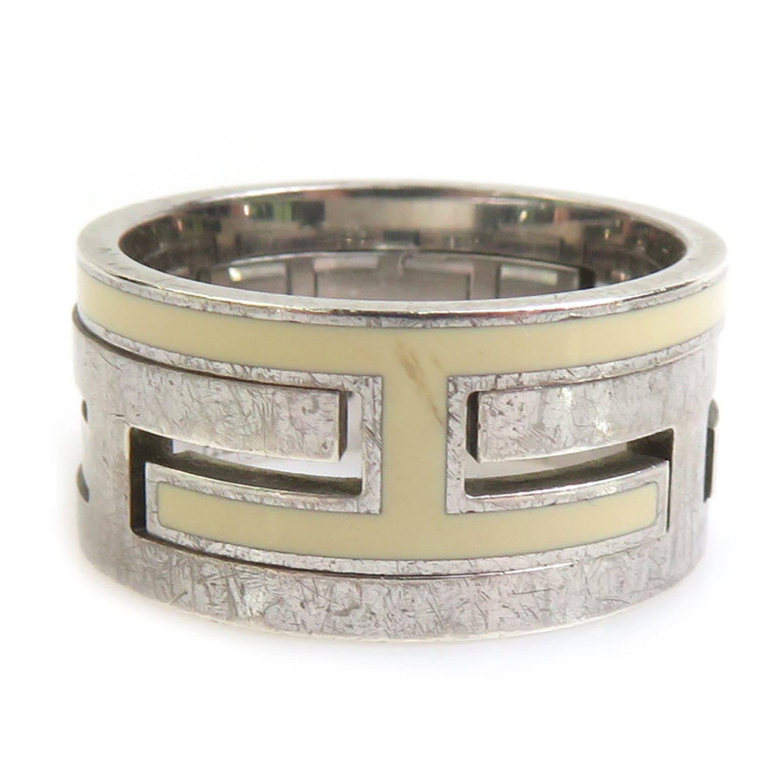 Silver Enamel Ring 925 Band Hermes: Silver Enamel Ring 925 Band Hermes Off-white enamel and silver 925 band ring from Hermes, featuring a subtle design. The item bears traces of usage with minor scratches and dirt, but remains in good c