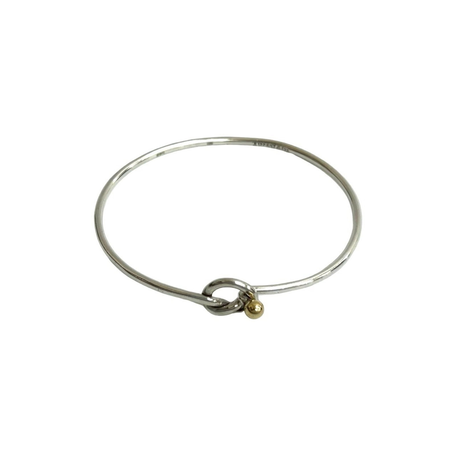 Tiffany Bangle Silver 925 Yellow Gold (18K): Tiffany Bangle Silver 925 Yellow Gold (18K) This Tiffany bangle features a beautiful combination of silver 925 and yellow gold (18K) for a touch of luxury. The 16.5cm length provides a comfortable