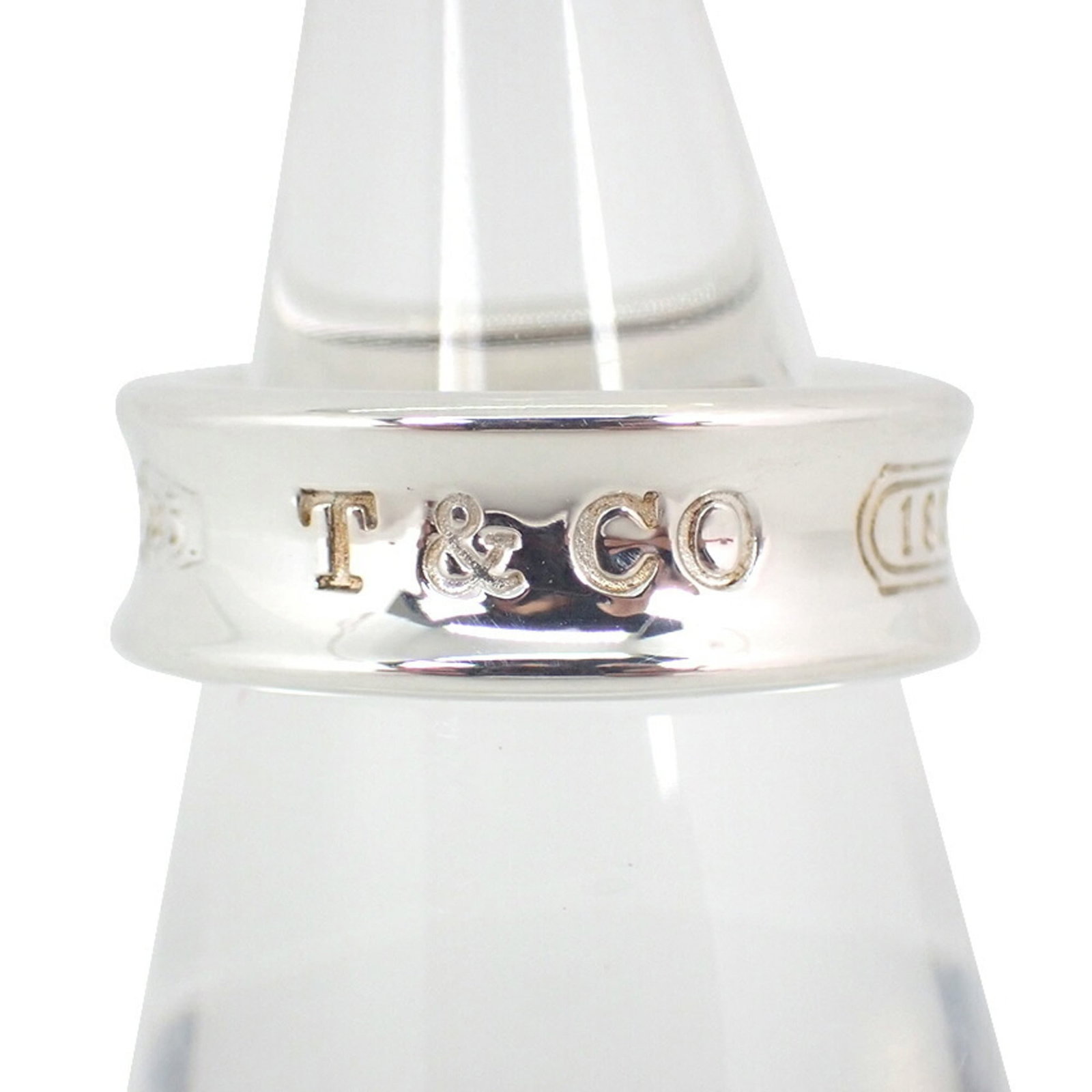 Sterling Silver Ring Tiffany Band: Sterling Silver Ring Tiffany Band Sterling silver Tiffany band ring in excellent condition, with hardly any signs of wear. This beautiful piece features the iconic Tiffany brand and is made from high-