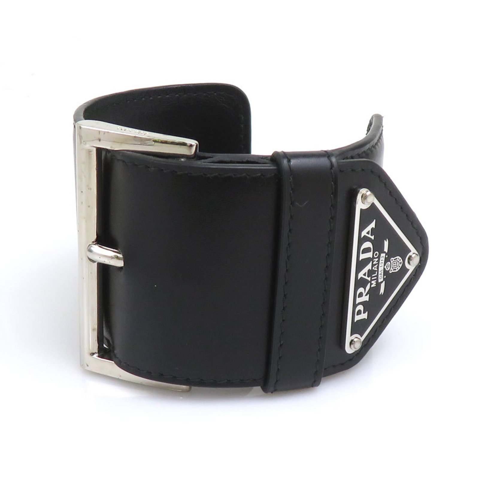 Leather Prada Bangle: Leather Prada Bangle This Prada leather bangle boasts sleek, sophisticated design in black. Its durable leather material has developed some scratches and dirt over time, giving it a worn-in look.