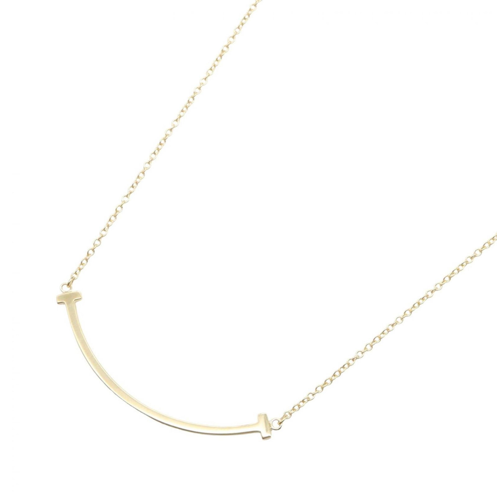 Tiffany & Co. T Smile Small Necklace 18K (Yellow Gold) Women'S Jewelry Gold Tone: Tiffany & Co. T Smile Small Necklace 18K (Yellow Gold) Women'S Jewelry Gold Tone Tiffany & Co.'s T Smile Small Necklace in 18K yellow gold is a delicate and elegant piece. The necklace features a 6mm