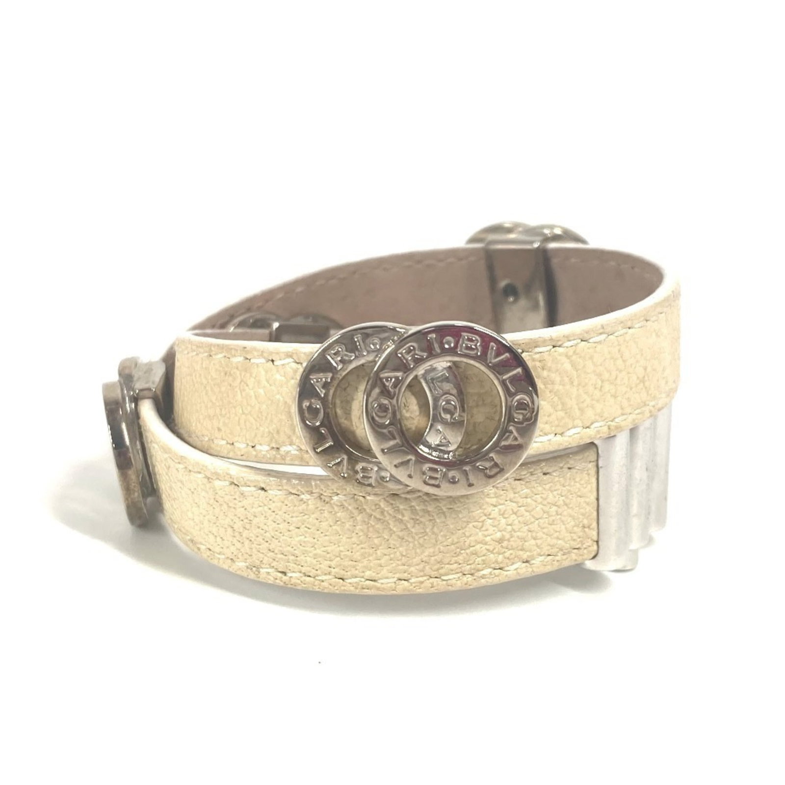 Leather Bvlgari Charm Bracelet: Leather Bvlgari Charm Bracelet Bvlgari's iconic charm bracelet features high-quality leather in a timeless beige hue, adding a touch of elegance to any outfit. With its classic design and subtle wear 