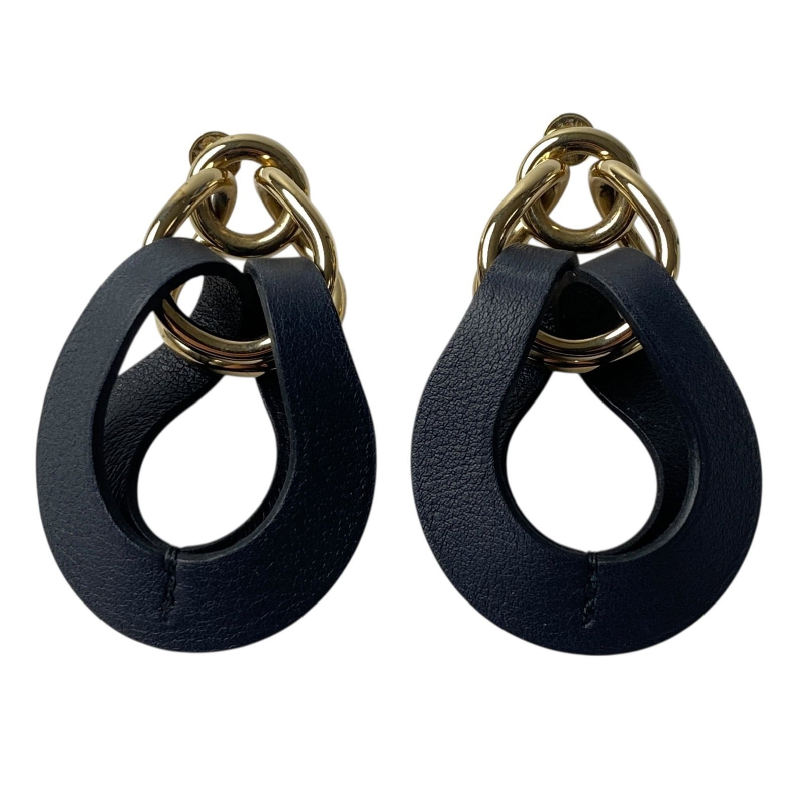 Hermes Stud Earrings Leather: Hermes Stud Earrings Leather Stud earrings from the iconic French fashion house Hermes, crafted from high-quality leather in sleek black and gold tones. The subtle scratches and minor wear on these li