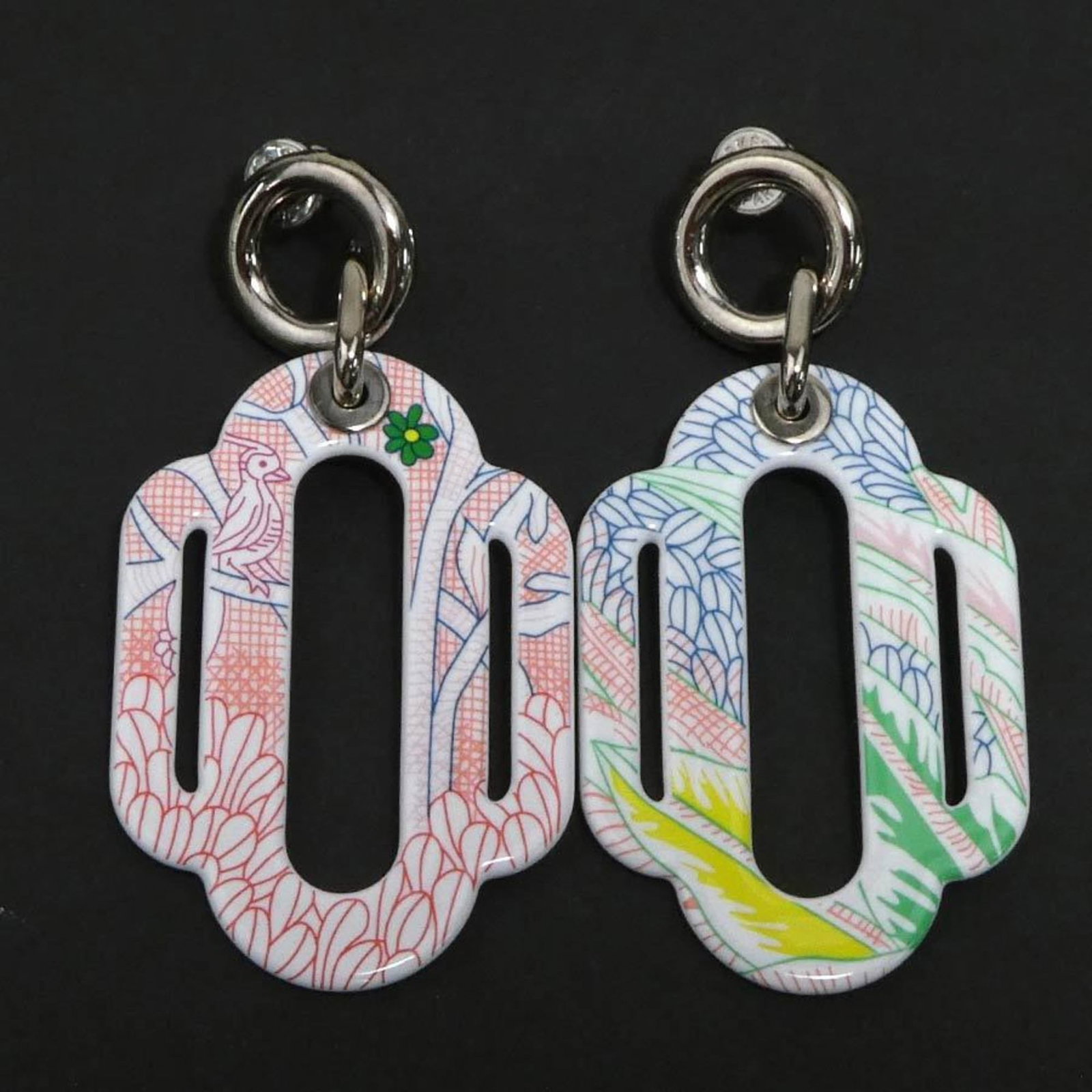 Metal enamel earrings by Hermes: Metal enamel earrings by Hermes Metal enamel earrings by Hermes, featuring multi-color designs in silver metal, with a drop earring style and dimensions of 60.00mm x 28.00mm. The earrings bear a few t
