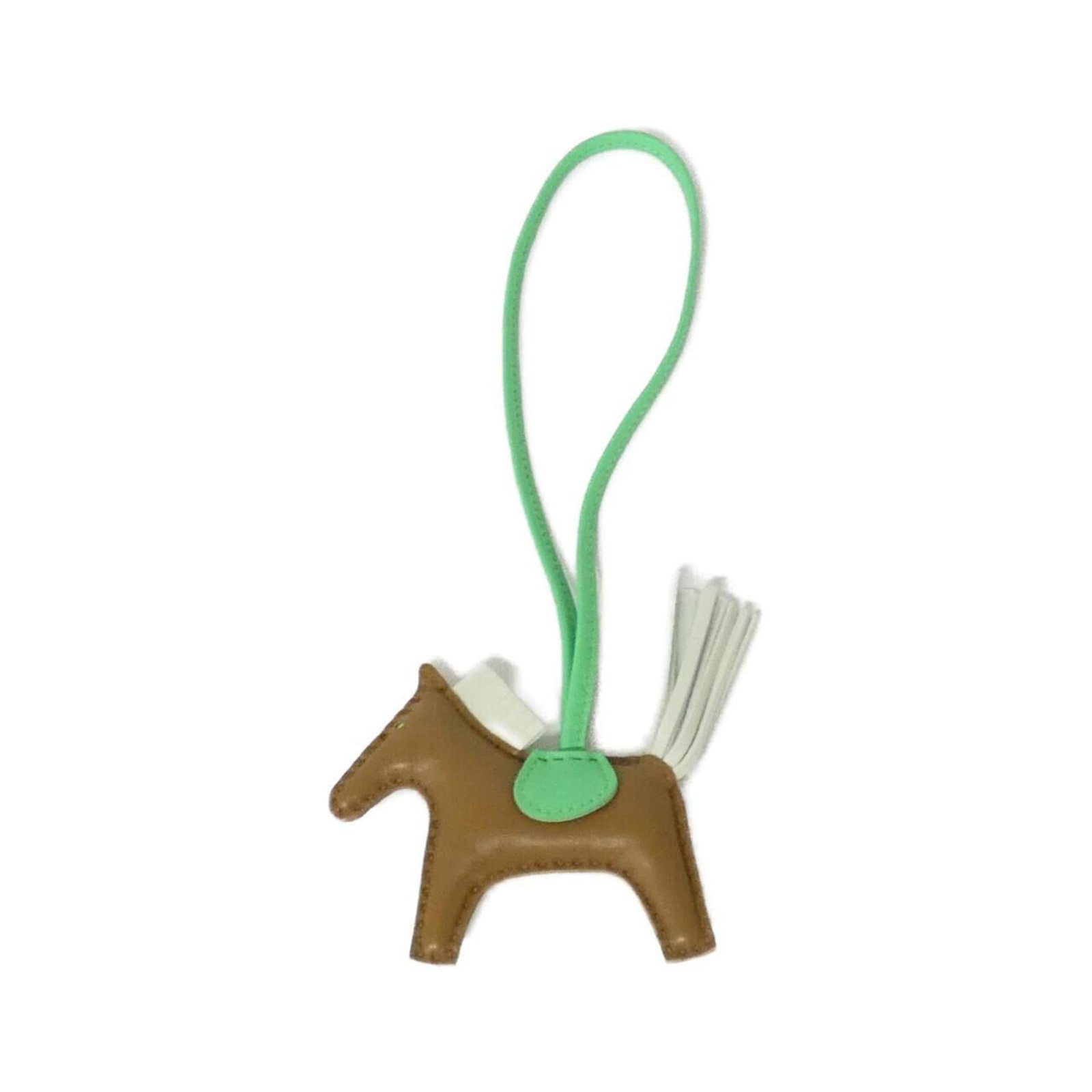 Hermes Handbag Charm Agneau Milo: Hermes Handbag Charm Agneau Milo Agneau Milo charm from Hermes, a brown handbag accessory with a kraft finish. Measuring 75mm x 85mm, it features some scratches and dirt but remains in very good