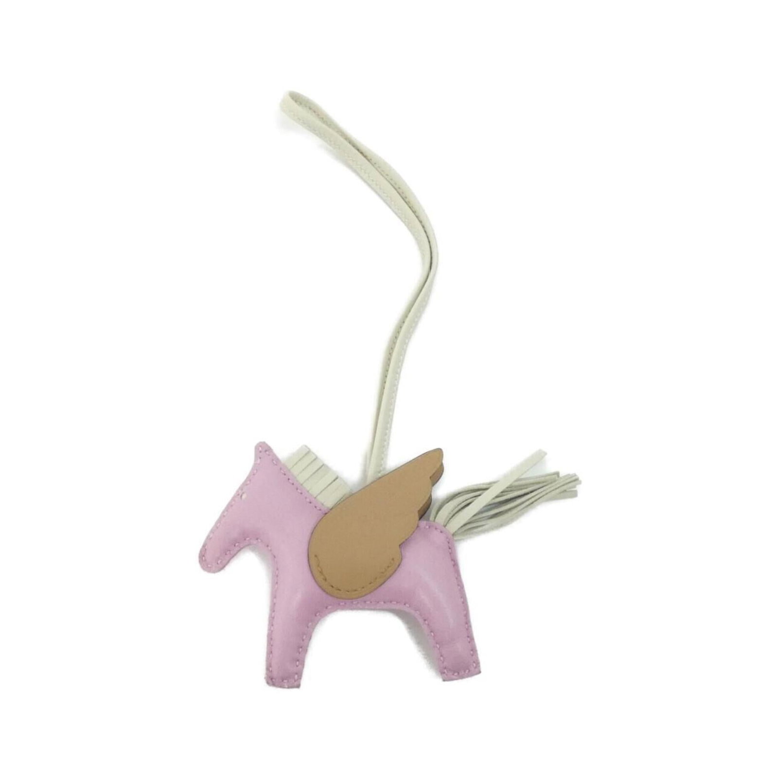 Hermes Handbag Charm Agneau Milo: Hermes Handbag Charm Agneau Milo Agneau Milo Handbag Charm by Hermes, featuring a beautiful pink hue. This used charm boasts a unique agneau milo material and measures approximately 75mm x 85mm in