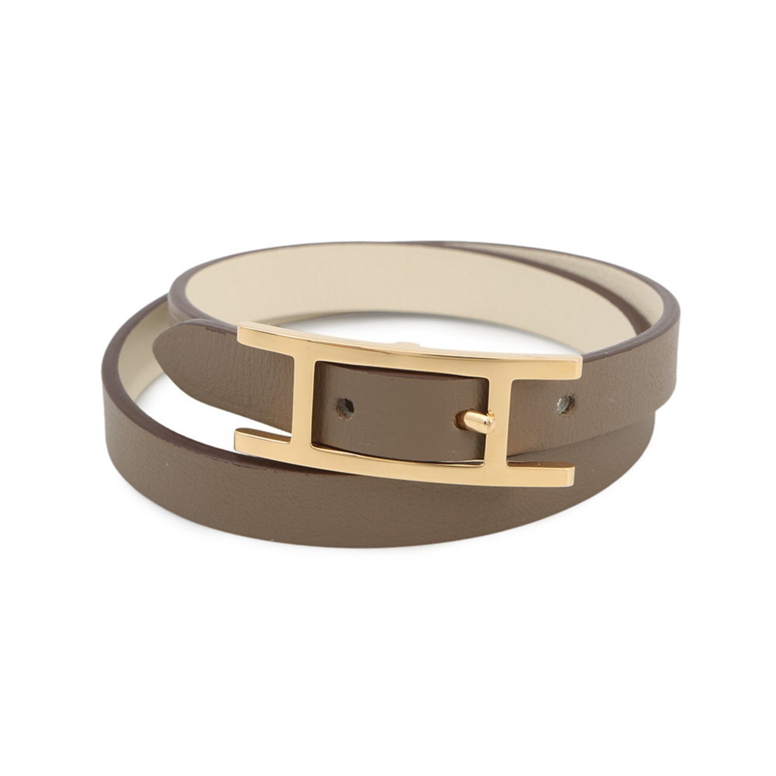 Swift leather bracelet Hermes: Swift leather bracelet Hermes Swift leather bracelet from Hermes, featuring etoupe gray color and adjustable length. This mint condition, like new item boasts the iconic Swift leather style, a