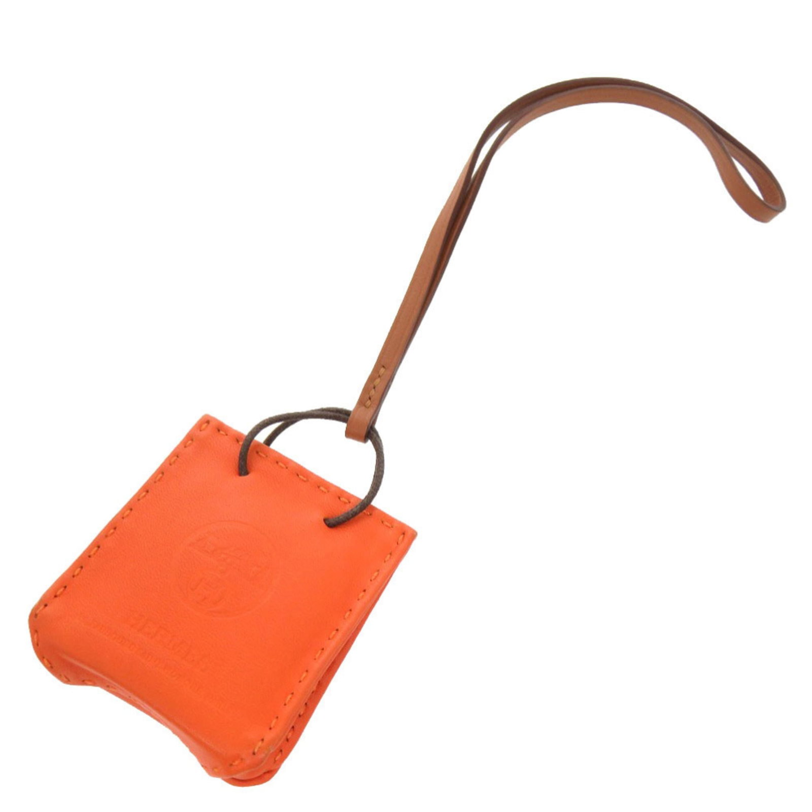 Hermes handbag leather agneau charm: Hermes handbag leather agneau charm Agneau leather charm from Hermes features an orange hue, adding a pop of color to any outfit. The small size and delicate design make it a versatile accessory that