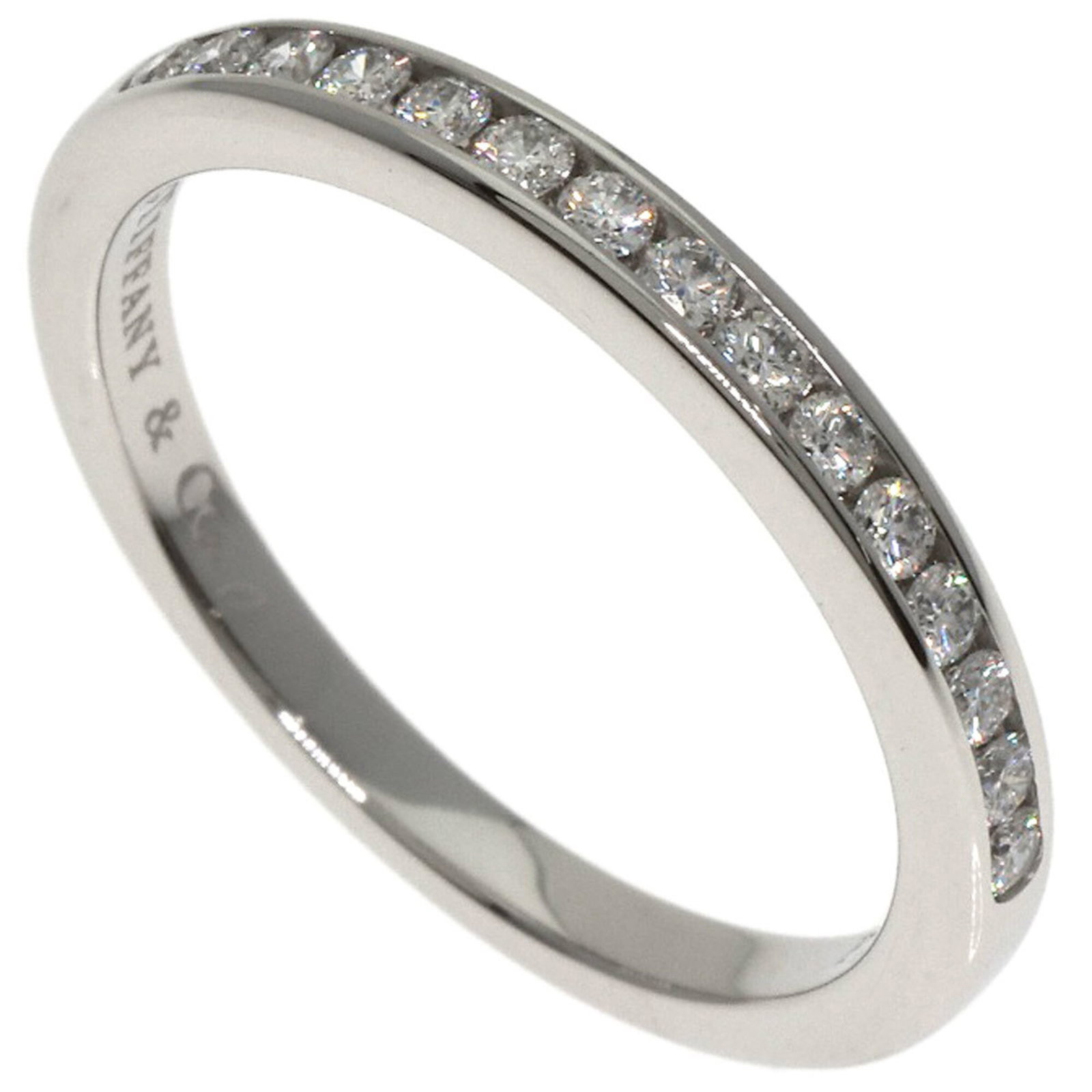 Platinum ring by Tiffany band: Platinum ring by Tiffany band Platinum band ring by Tiffany features a diamond stone and is made from high-quality platinum. The ring has been well-cared for, with only minor signs of wear visible,