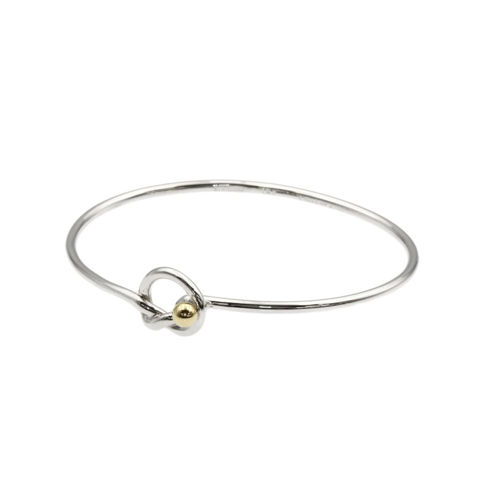 Tiffany Charm of Bracelet: Tiffany Charm of Bracelet Tiffany Charm of Bracelet, an elegant gold charm bracelet with a silver tone, features a delicate yellow metal design. The 18K gold construction provides a touch of luxury, w