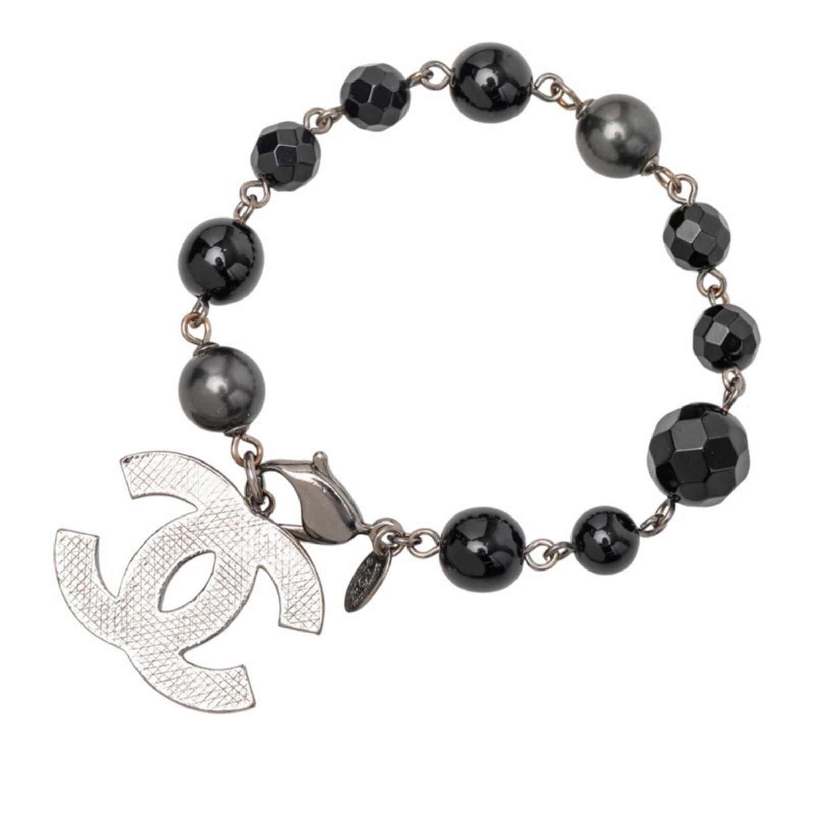 Charm of Chanel: Charm of Chanel Charm of Chanel is a black charm bracelet with a length of 15.5cm, bearing some traces of usage and minor scratches/dirt. The condition is described as very good, reflecting its