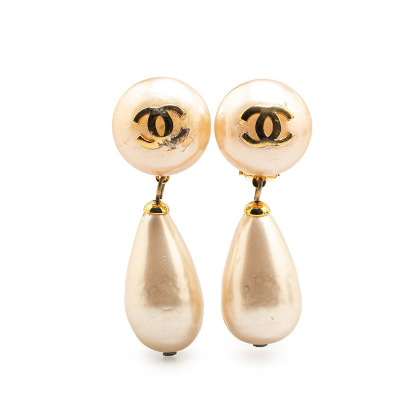 Chanel Clip Earrings: Chanel Clip Earrings Gold clip earrings from the iconic Chanel brand, featuring a classic design with subtle details. The earrings show signs of gentle use, with minor scratches and dirt visible, but
