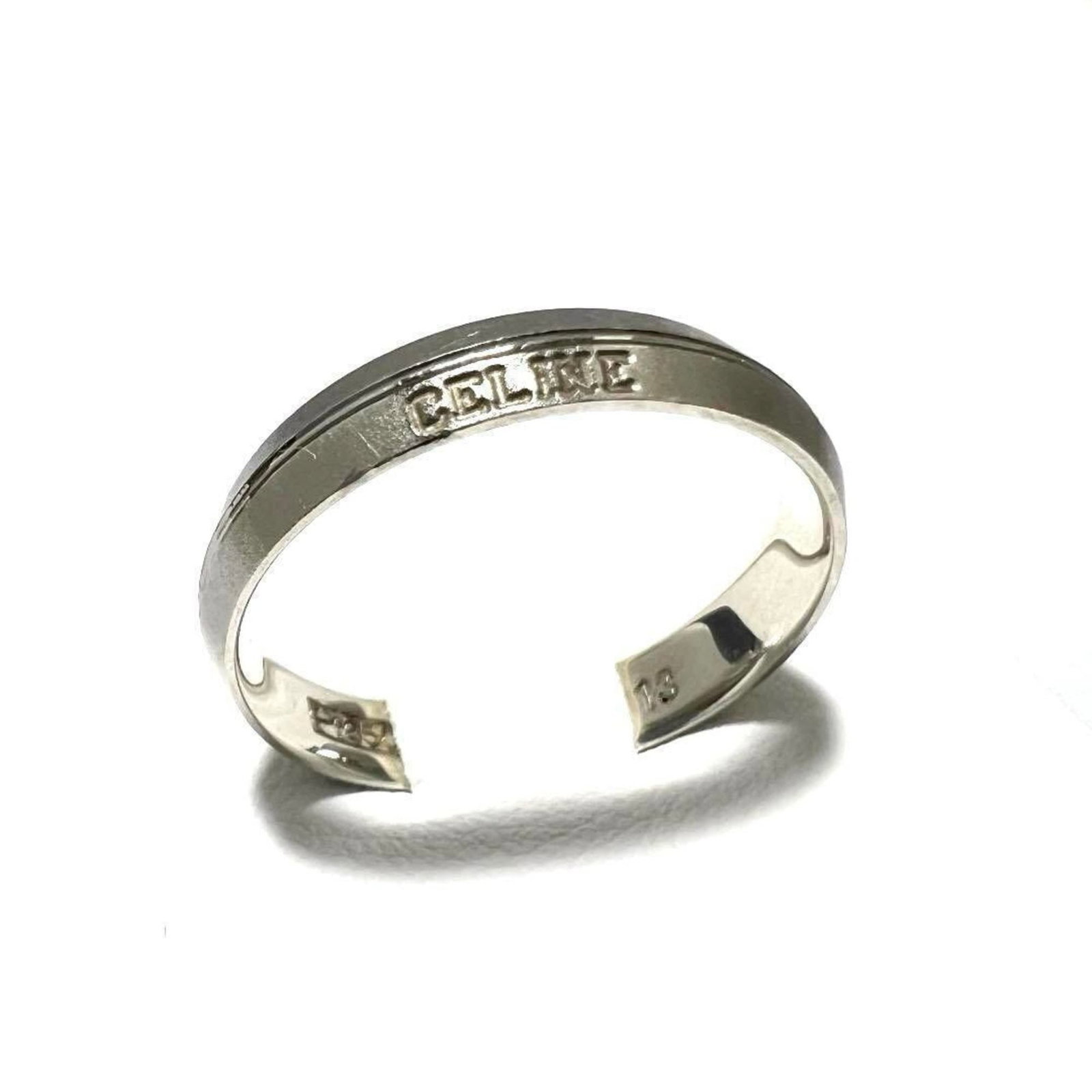 Celine Band Ring Platinum 850: Celine Band Ring Platinum 850 Platinum 850 band ring from Celine, featuring a durable and luxurious metal construction. The ring bears some minor scratches and dirt, but remains in very good