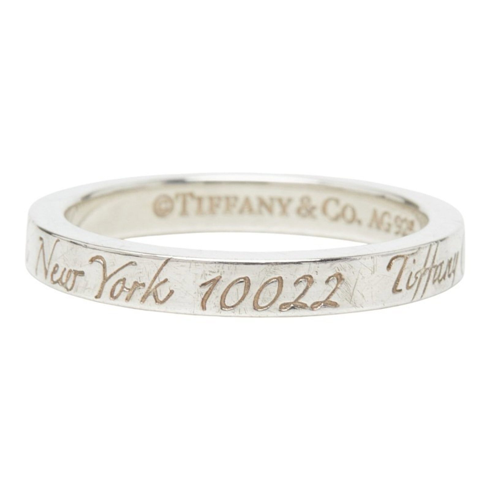 Tiffany Band Ring Silver 925: Tiffany Band Ring Silver 925 Silver 925 Tiffany Band Ring for Women, Us Size 6. This used band ring features silver 925 material and bears a signature. In very good condition with some scratches and d