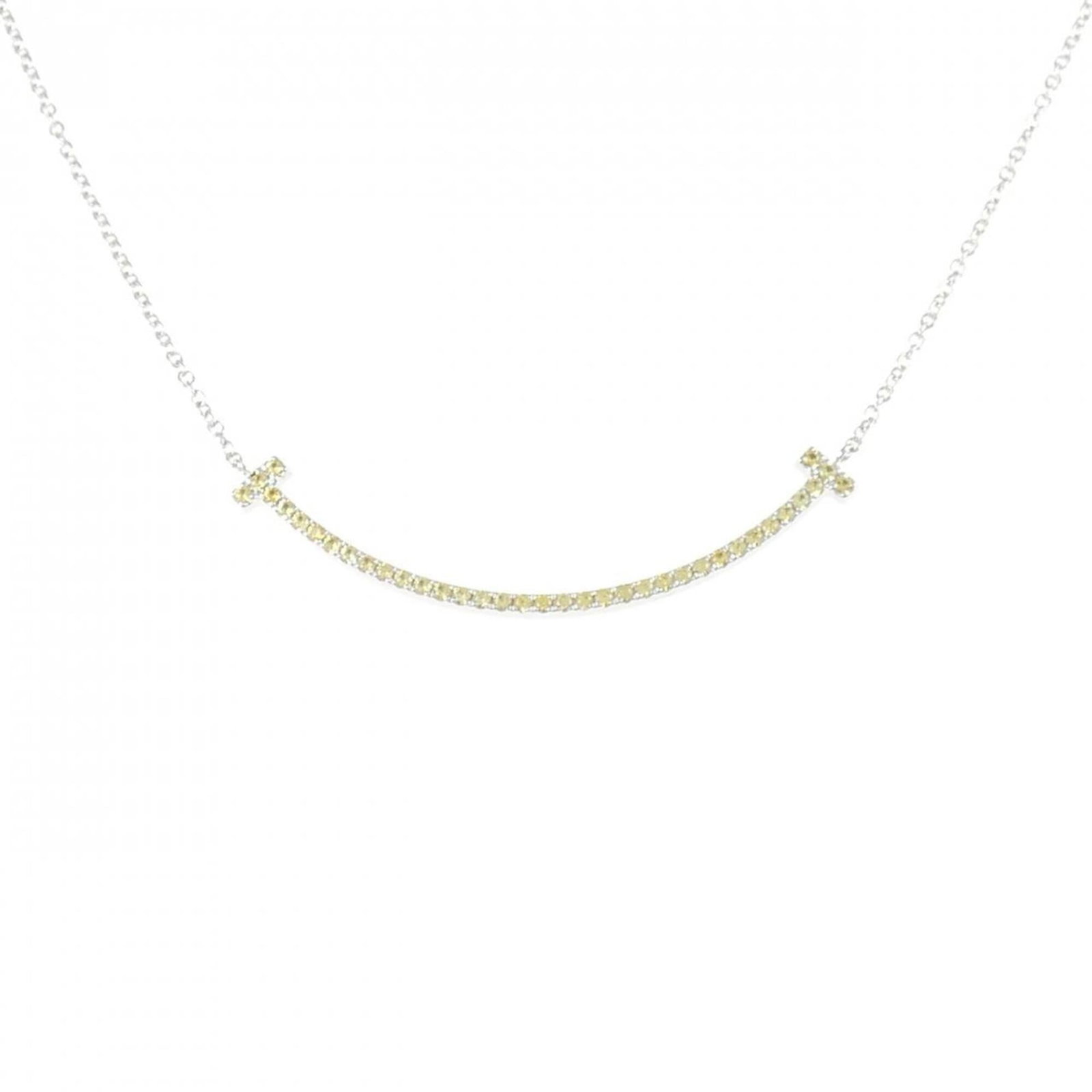 Smile of Tiffany T Necklace Small: Smile of Tiffany T Necklace Small Small Tiffany & Co. necklace featuring a white gold sapphire pendant, measuring 4mm x 39mm, suspended from a 46 cm chain. This elegant piece showcases the beauty of a