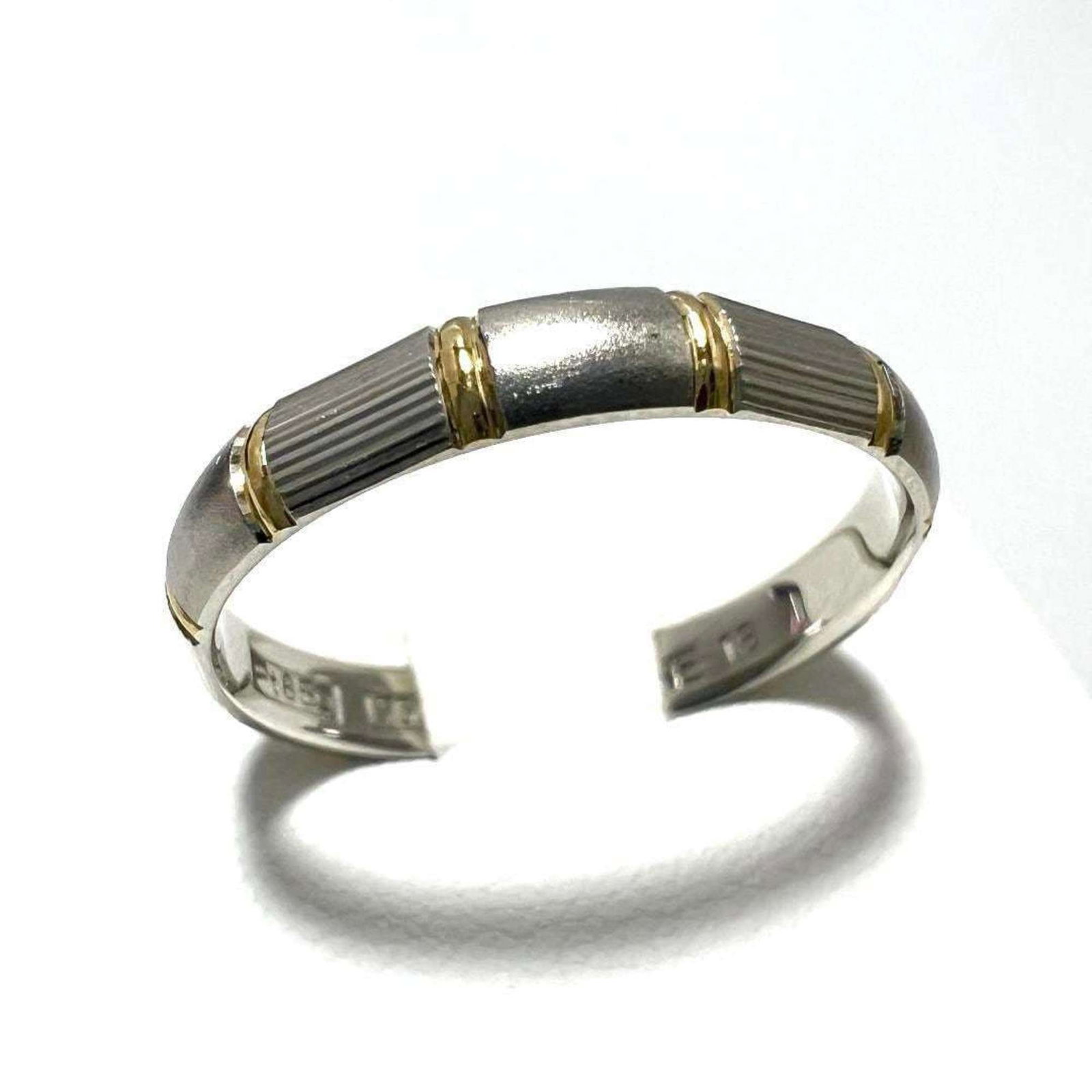 Yellow Gold Platinum Ring Celine Band: Yellow Gold Platinum Ring Celine Band Platinum and yellow gold combine in this elegant Celine band ring, showcasing a subtle yet sophisticated design. Made from high-quality materials, the ring featur