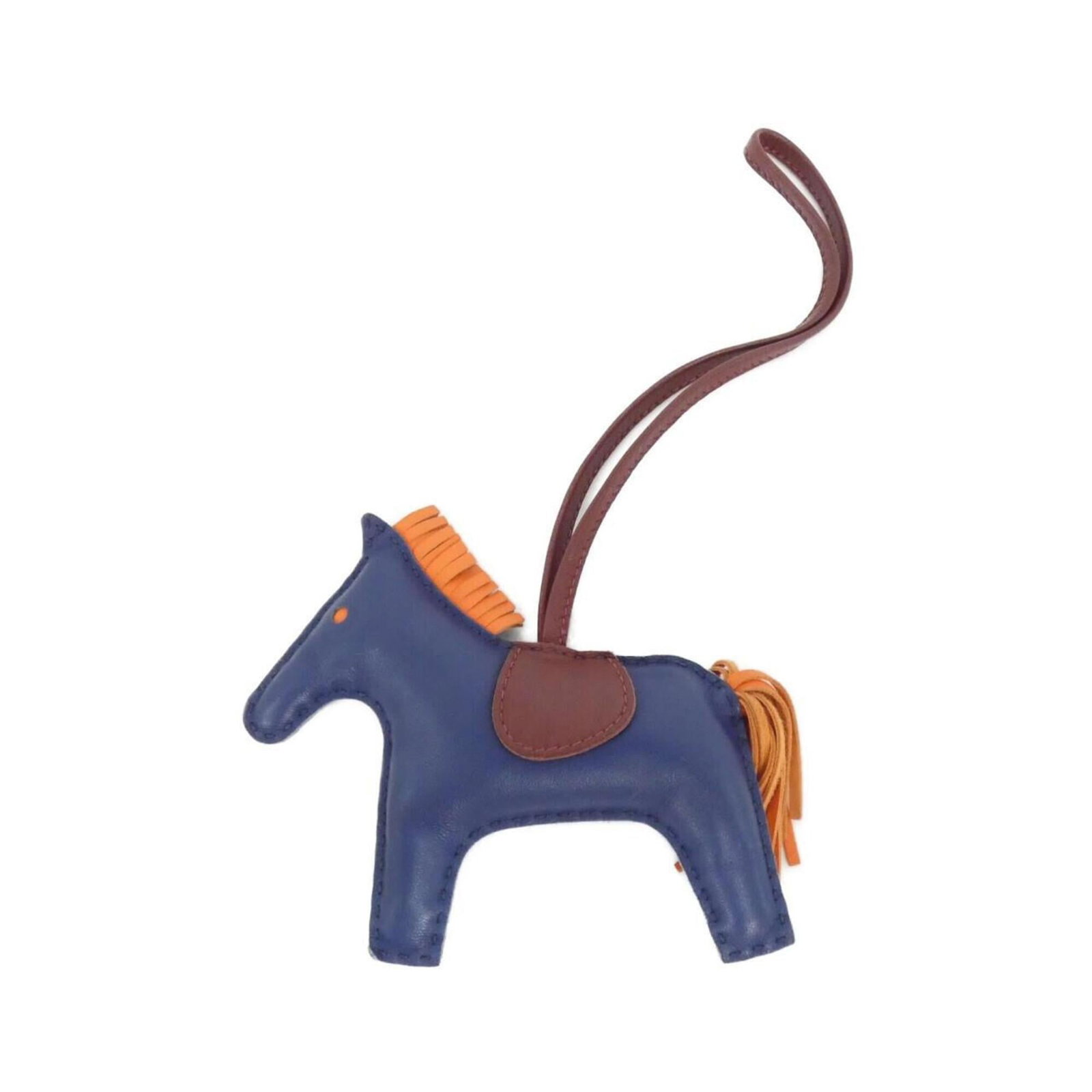 Hermes Handbag Charm Agneau Milo: Hermes Handbag Charm Agneau Milo Agneau Milo charm from the iconic Hermes handbag collection, featuring a vibrant blue and orange hue. This used charm showcases some minor scratches and dirt, but