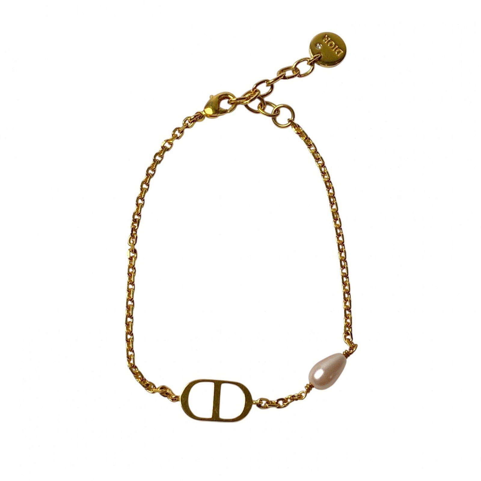 Dior Charm Christian: Dior Charm Christian The Dior Charm Christian bracelet boasts a sleek gold design, measuring 20cm in length. With its subtle scratches and minor signs of wear, this used charm bracelet still exudes a