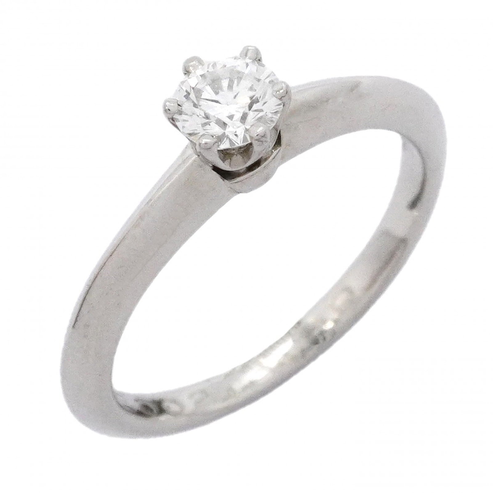 Platinum ring by Tiffany band: Platinum ring by Tiffany band Platinum ring by Tiffany features a diamond stone set in a band design. The item bears traces of usage and minor scratches, with some dirt visible but overall in good con