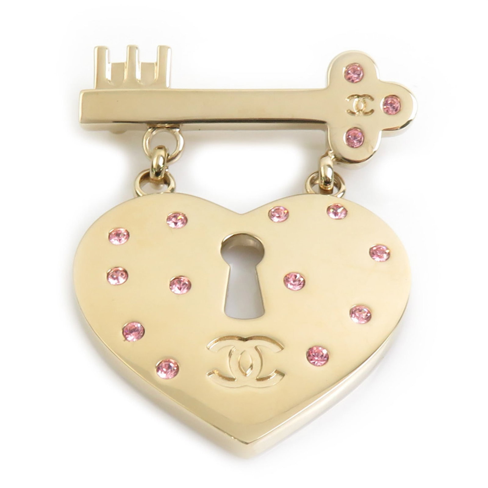 Metal rhinestone Chanel brooch: Metal rhinestone Chanel brooch Metal rhinestone Chanel brooch in gold and pink hues, featuring intricate metalwork with prominent rhinestones. The piece measures approximately 5.5cm x 4.5cm and shows